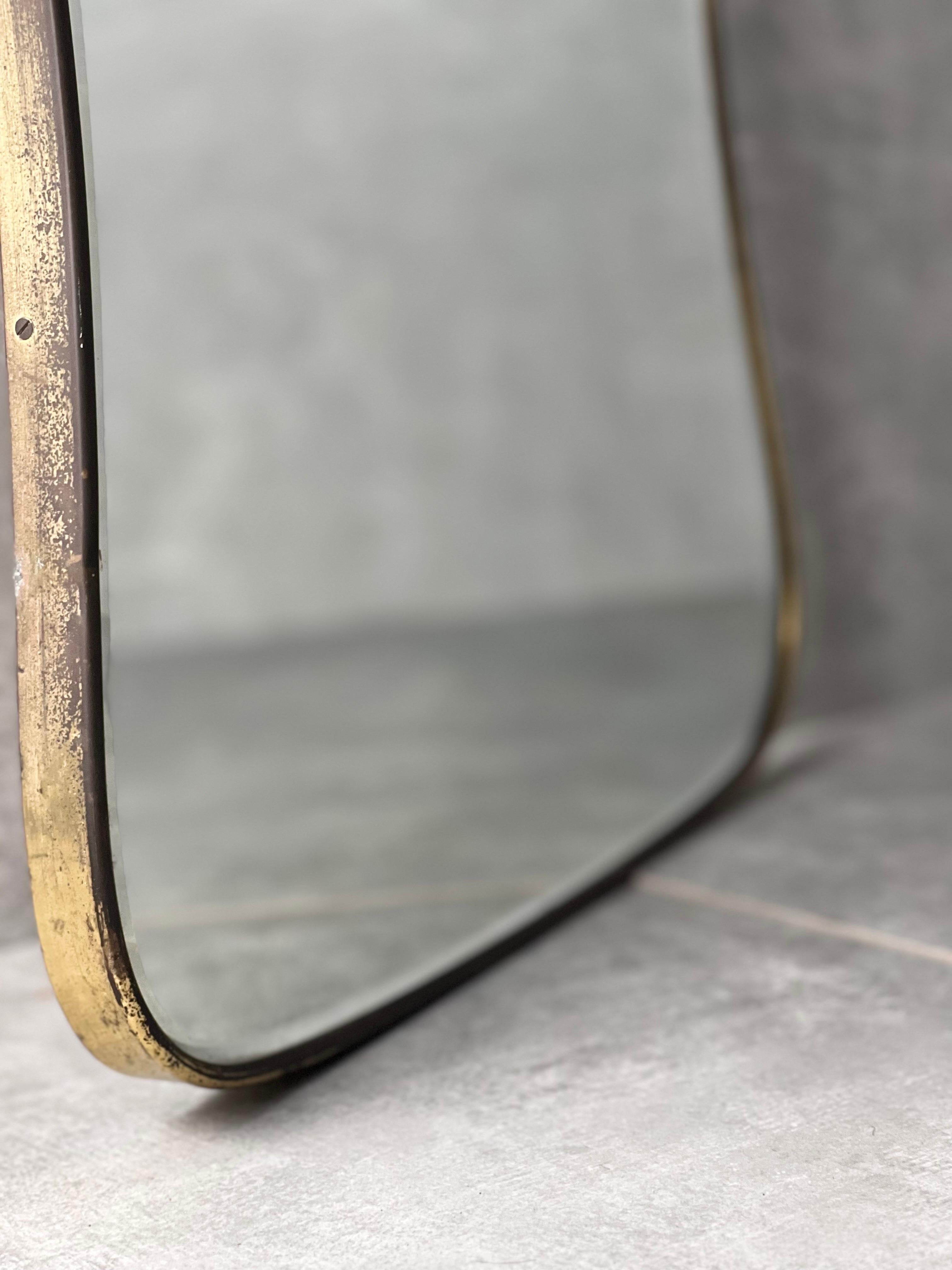 Mid-Century wall mirror with brass frame.