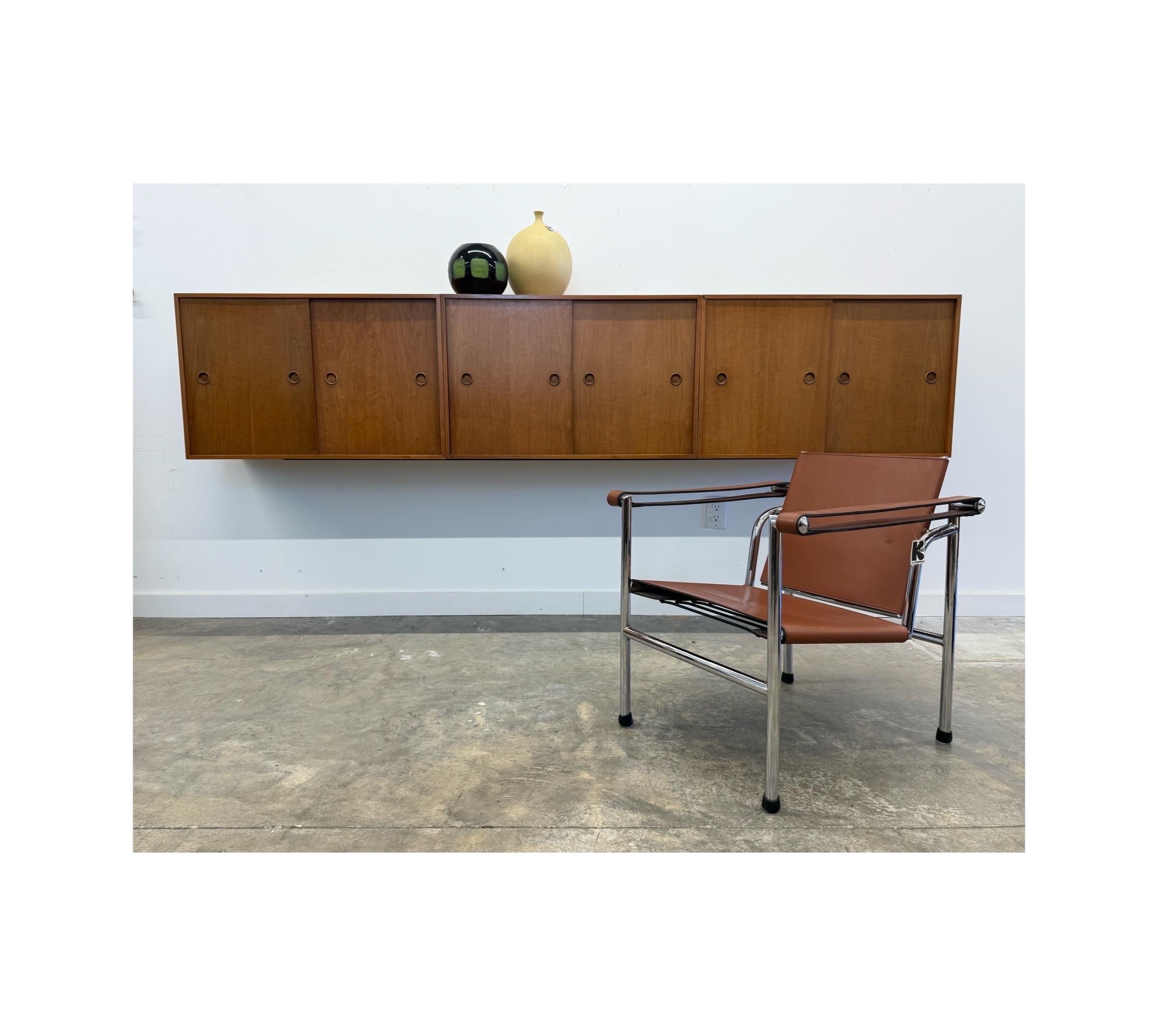 Monumental mid-century wall mounted cabinets. If a floating credenza or console is what you require, we have the perfect piece. Designed by Finn Juhl for Baker Furniture Company, circa 1950s.

This piece consists of three individual cabinets. Each