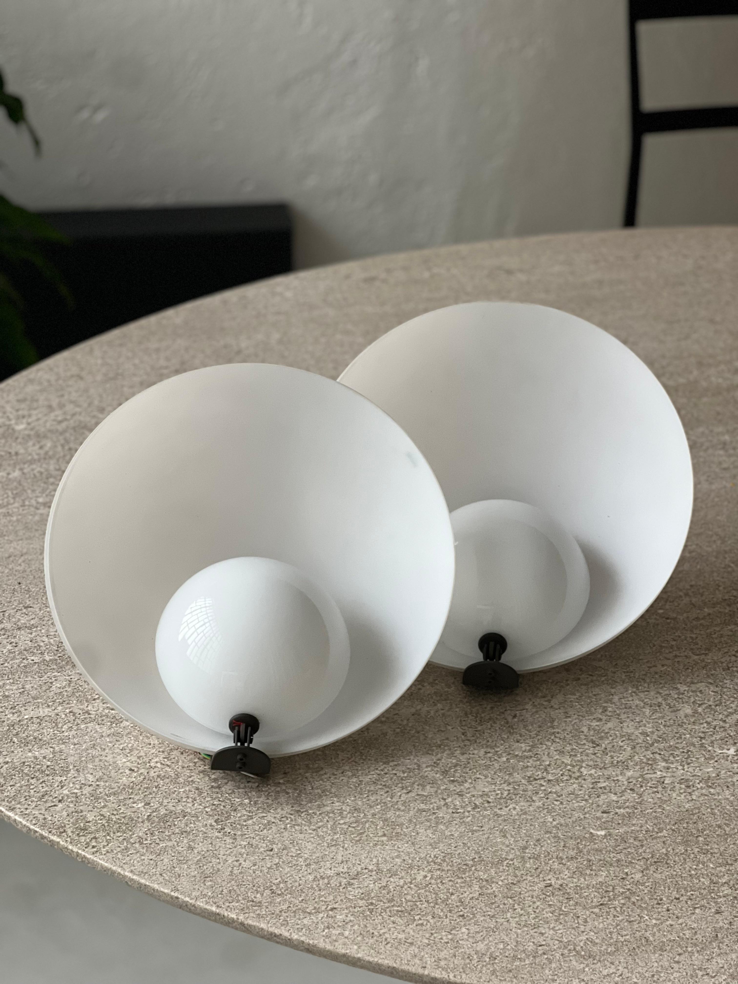 Mid Century Sconces - Murano Glass Wall Lamps - VeArt Collectible Lights

Beautiful, refined and attractive set of two Mid-Century Modern wall lamps / sconces in opaline Murano glass, manufactured by VeArt. They consist of two glass domes, one