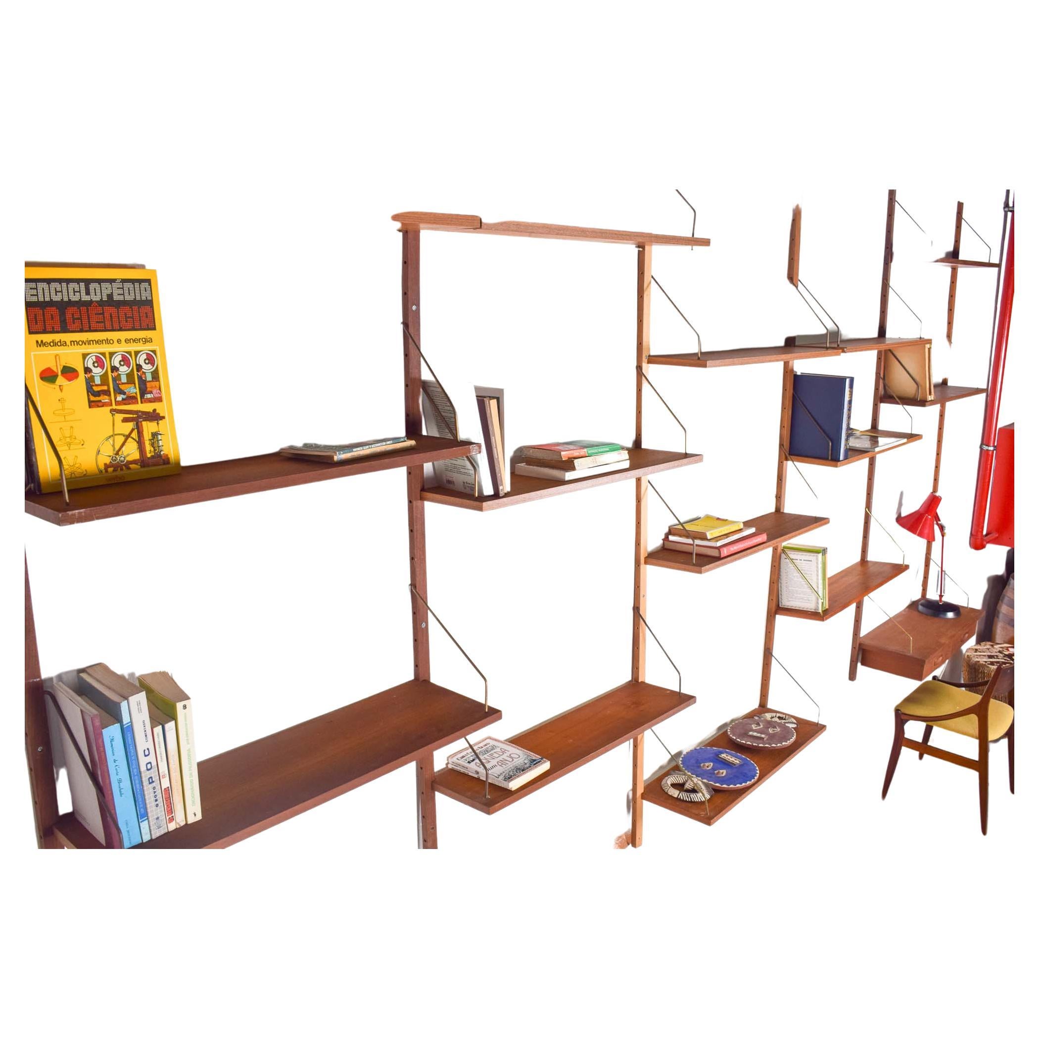 Danish teak wall unit designed by Kai Kristiansen for Feldballes Mobelfabrik, in the 60s. A teak wall unit system. Composed with several modules, 14 shelves and a desk with drawers which can be moved and arranged in different ways and be adjusted as