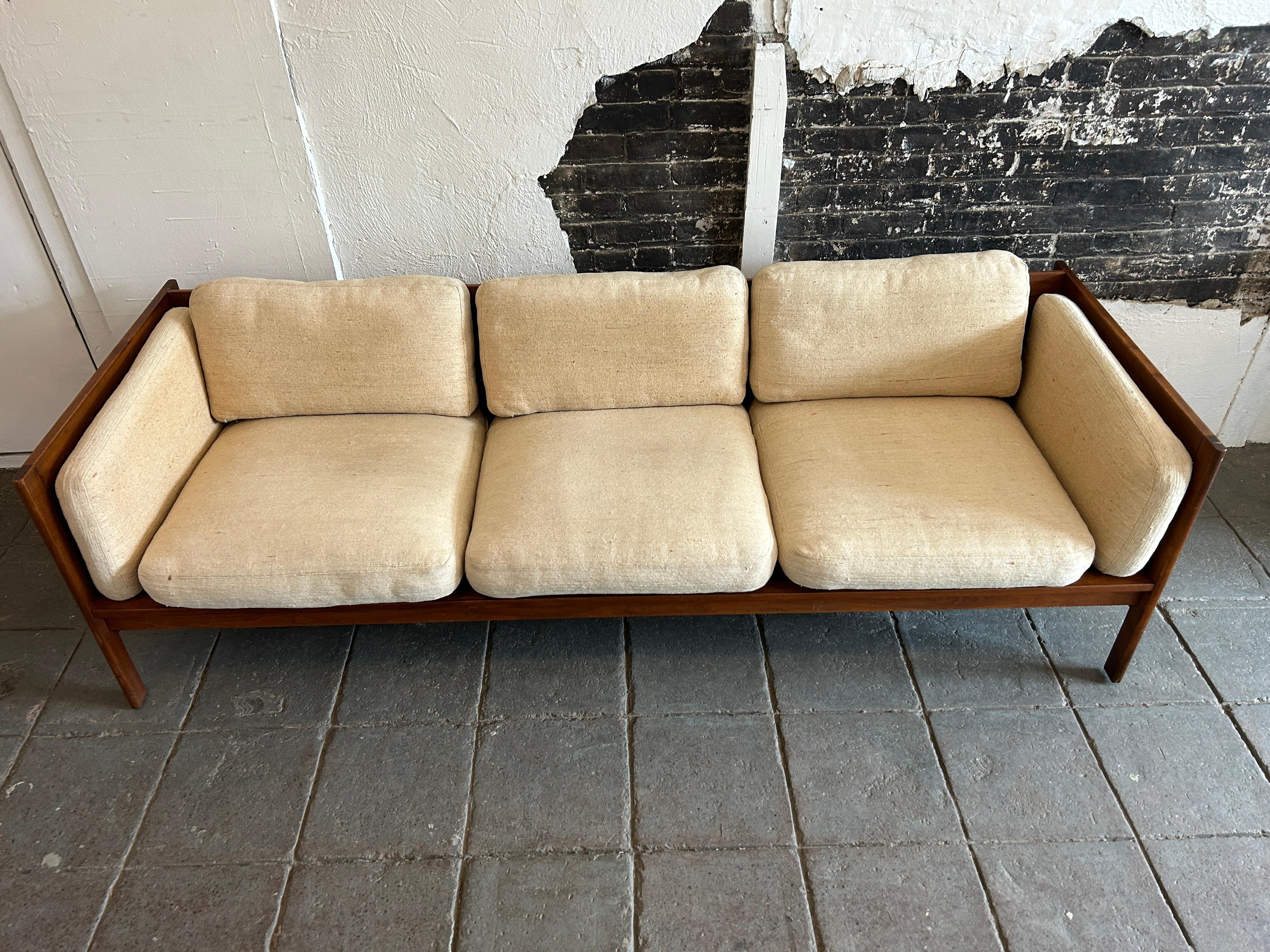 Midcentury walnut platform armed 3 seat Studio Craft sofa daybed. Has off white linen woven high end upholstery with heavy cushions. In vintage condition. Frame is very unique. Use as is or have it reupholstered. By Richard Artschwager at The