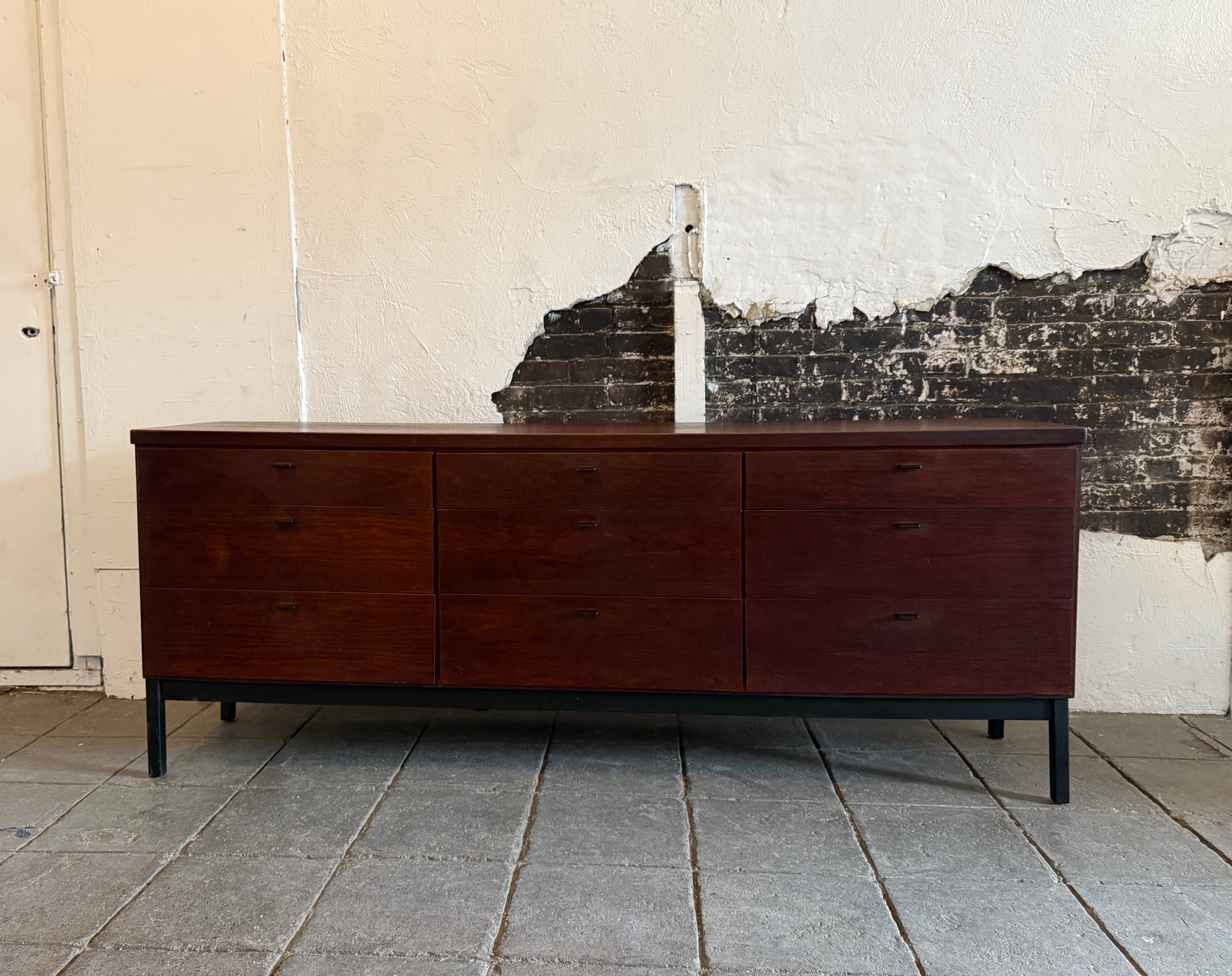 Mid century 9 drawer walnut dresser with black metal pulls by Jack Cartwright for Founders. Jack Cartwright for Founder mid century modern dresser with black accents. Light Oak wood drawers with dovetail joints. All drawers are clean and slide