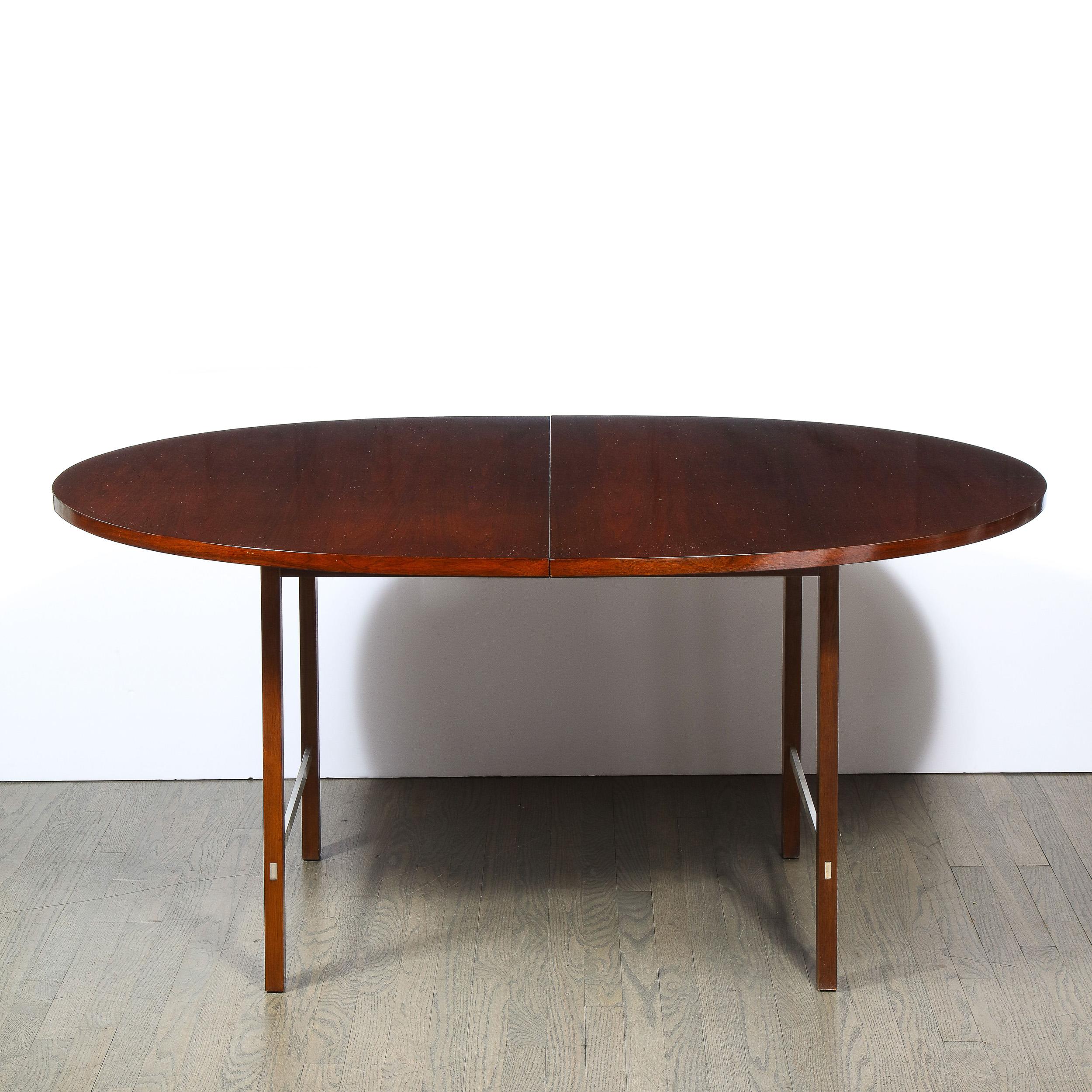 This refined Mid-Century Modern dining table was designed by the legendary Paul McCobb and realized for Calvin Furniture Company in the United States circa 1960. The table features an oval top and four volumetric rectangular legs all in solid