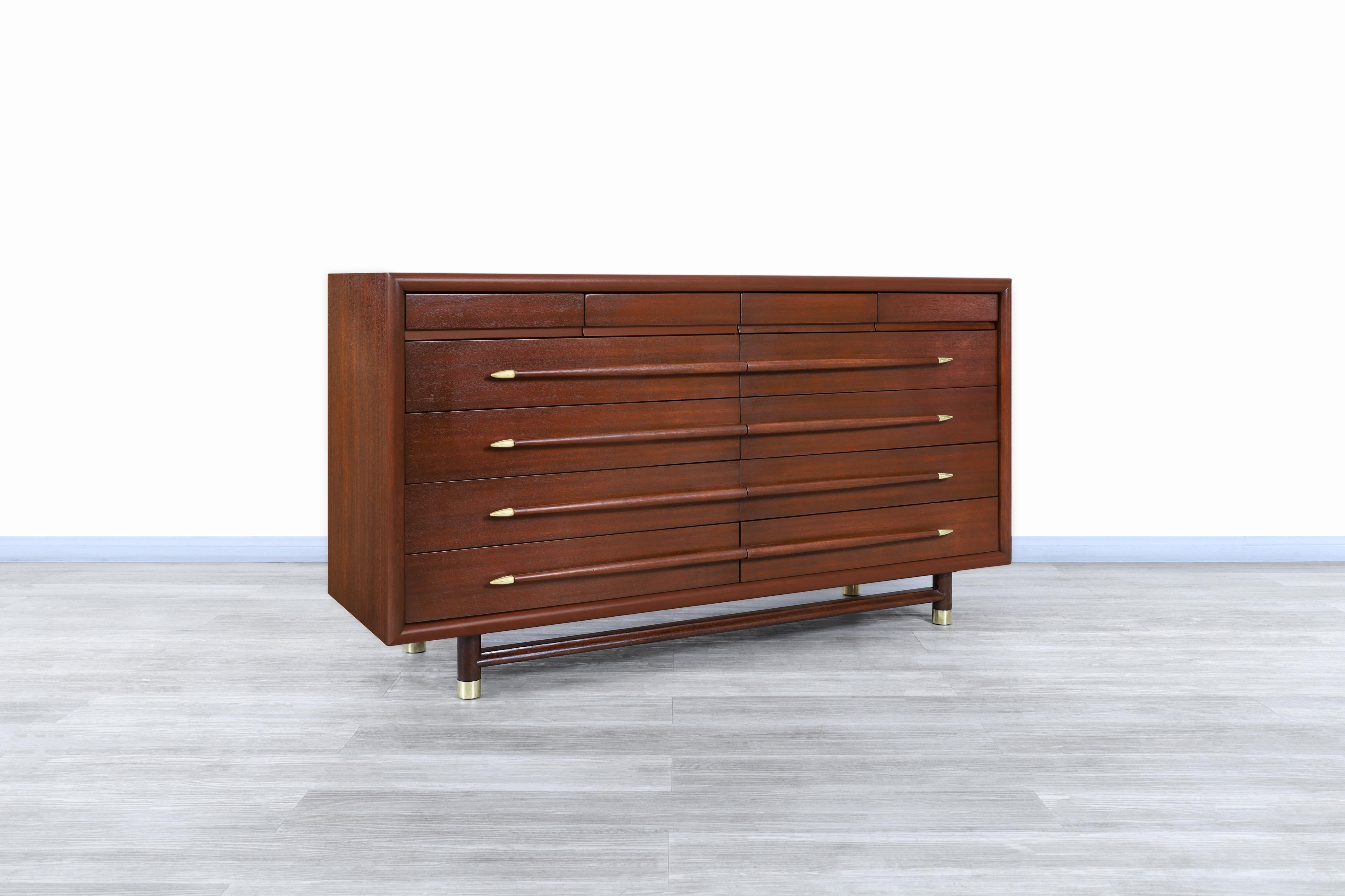 Wonderful mid-century walnut and brass dresser designed by John Keal for Brown Saltman in the United States, circa 1950s. This dresser has been built from the highest quality walnut-stained mahogany wood and has a highly functional design that