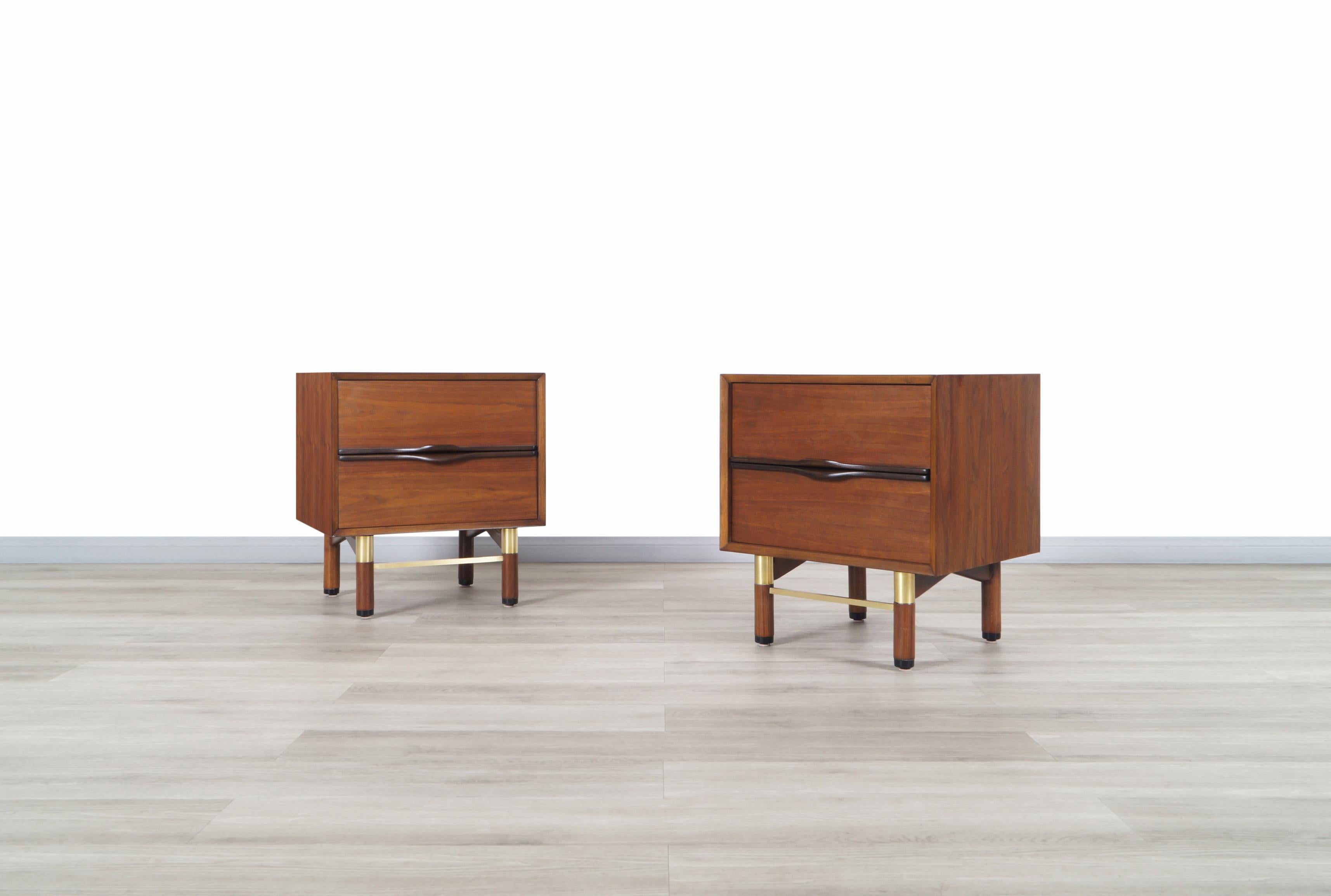 Fabulous mid century walnut and brass nightstands designed and manufactured in the United States, circa 1960s. These nightstands are made of walnut and have a minimalist design, that combined with its construction material, results in elegant and