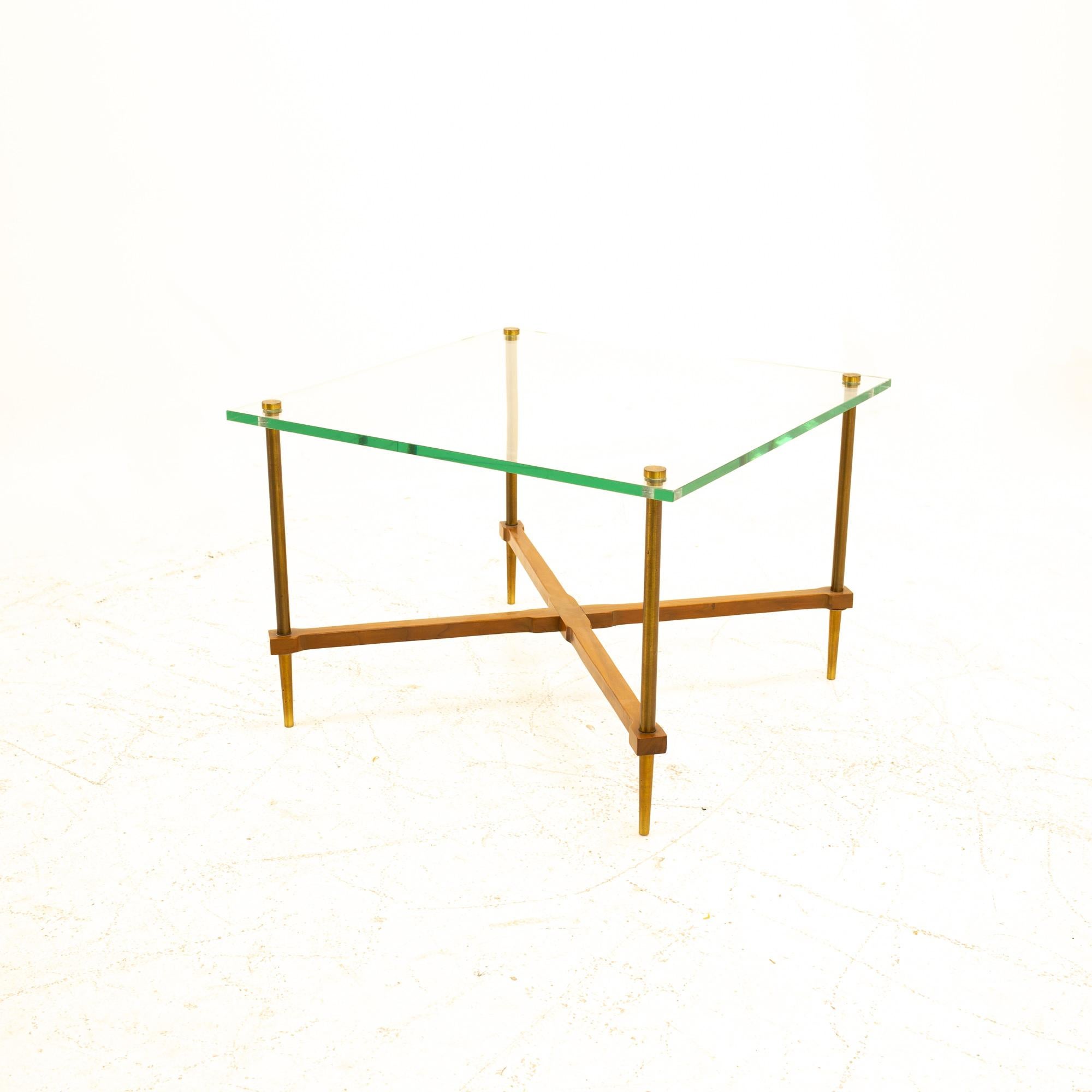 Mid Century walnut and brass X-base table with glass top
Table measures: 22 wide x 22 deep x 15.25 high 

All pieces of furniture can be had in what we call restored vintage condition. That means the piece is restored upon purchase so it’s free