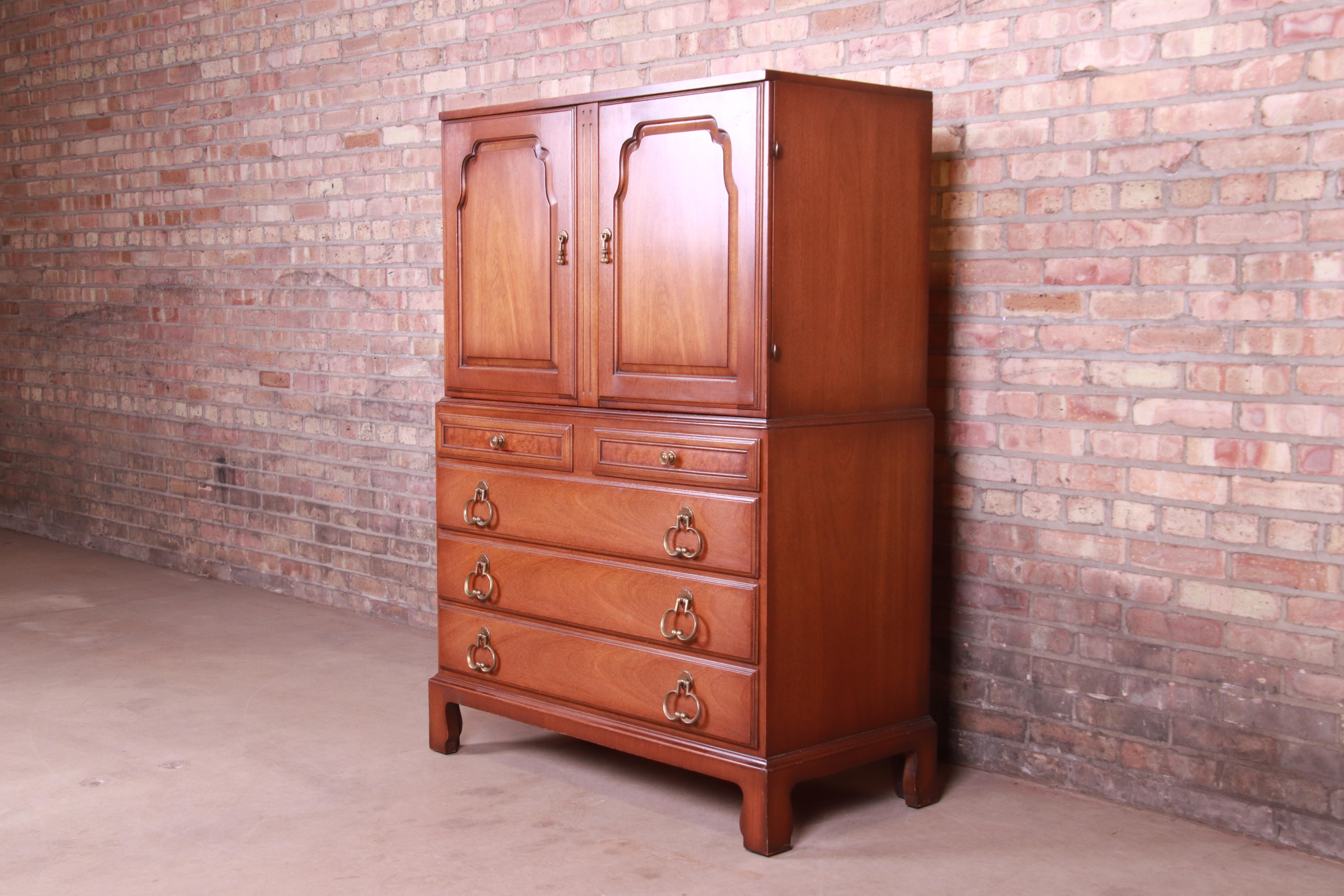 A gorgeous Mid-Century Modern highboy dresser chest

USA, circa 1960s

Walnut and burl wood, with white painted interior and original brass hardware.

Measures: 40.5