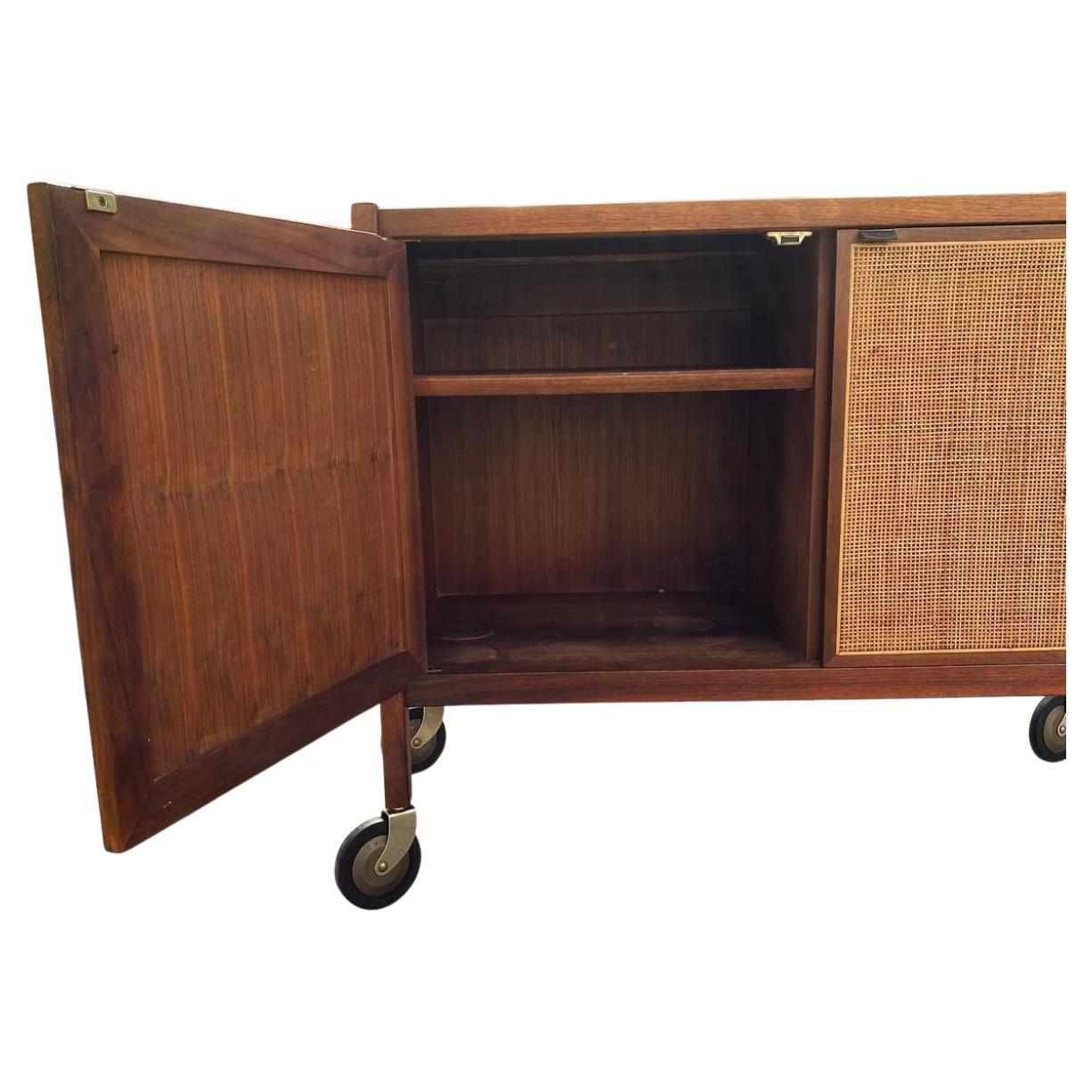 American Mid century walnut and cane bar cart on casters by Jack Cartwright Founders For Sale