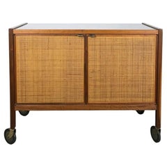 Mid century walnut and cane bar cart on casters by Jack Cartwright Founders