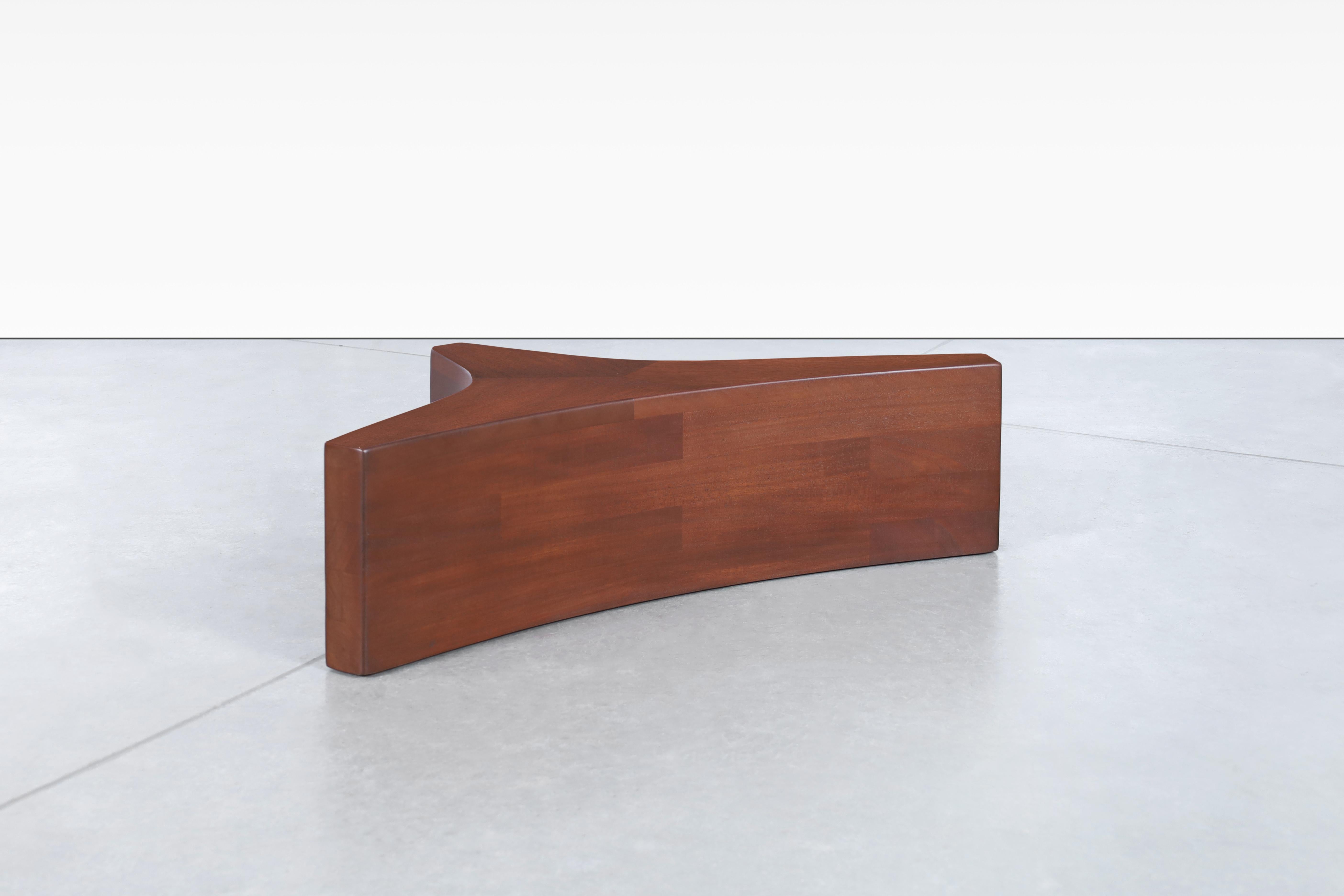 Beautiful mid-century walnut and glass biomorphic coffee table designed in the United States, circa 1960s. This coffee table is a true masterpiece inspired by the iconic designs of Vladimir Kagan. Crafted from beautiful walnut, this piece exudes
