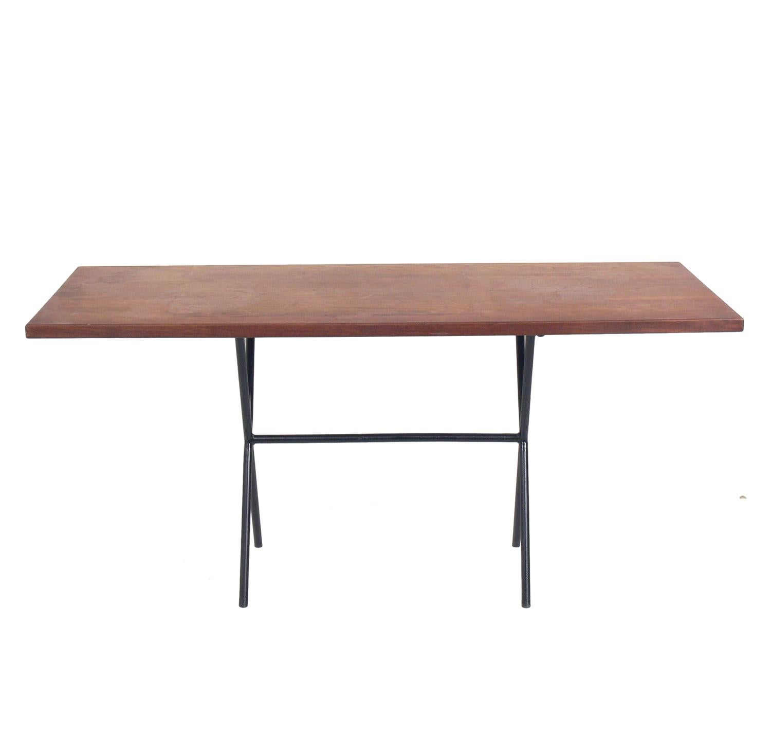 Midcentury walnut and iron X-base console table, in the manner of George Nelson, American, circa 1950s. It is a versatile size and can be used as a console or sofa table, or bar. The iron base has been repainted, and the walnut top is currently