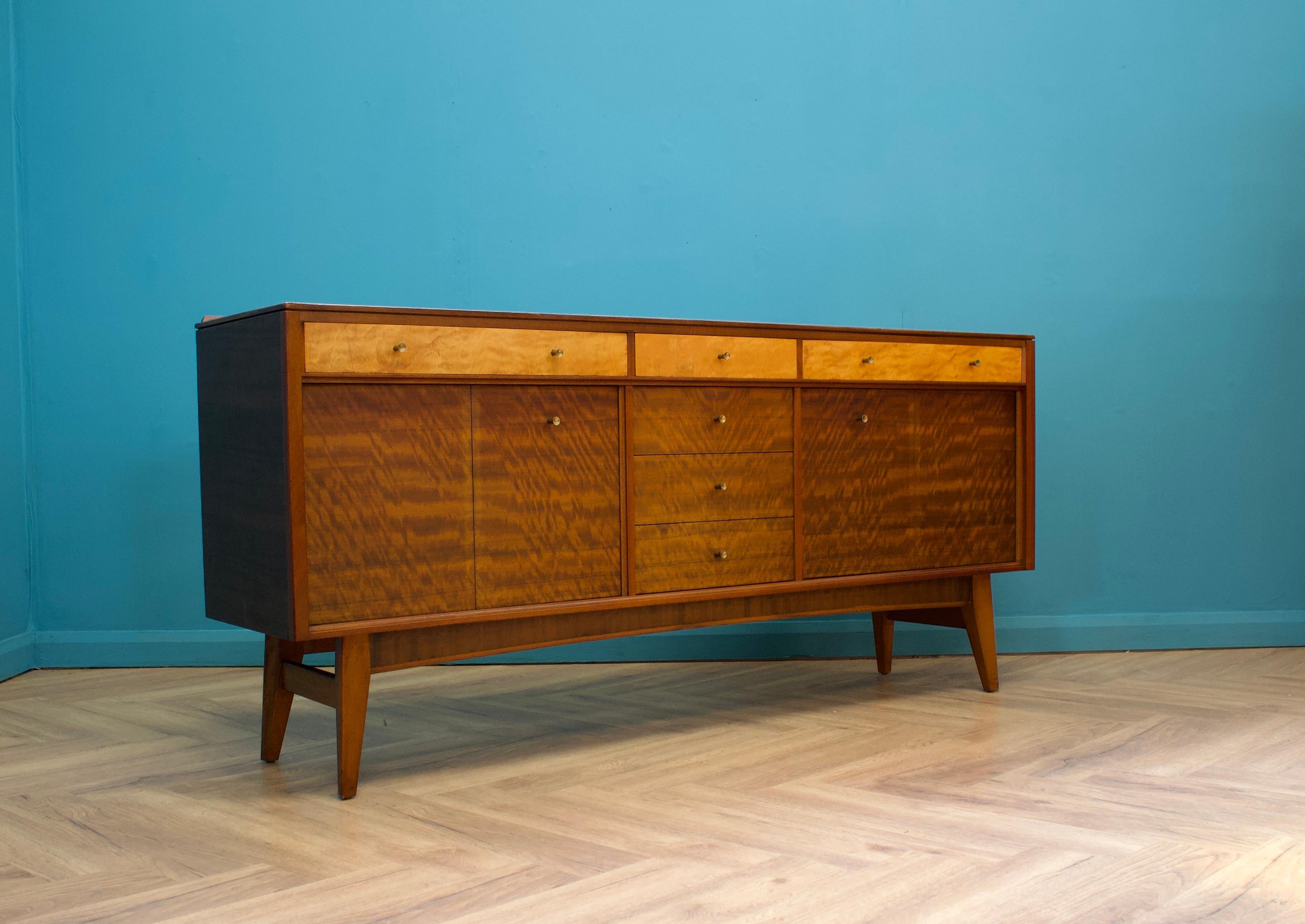 A walnut sideboard from Morris of Glasgow - designed by Neil Morris for the Cumbrae range

The attractive legs are slightly tapered and the handles are solid wood

Featuring two cupboards - with removable shelves and three drawers