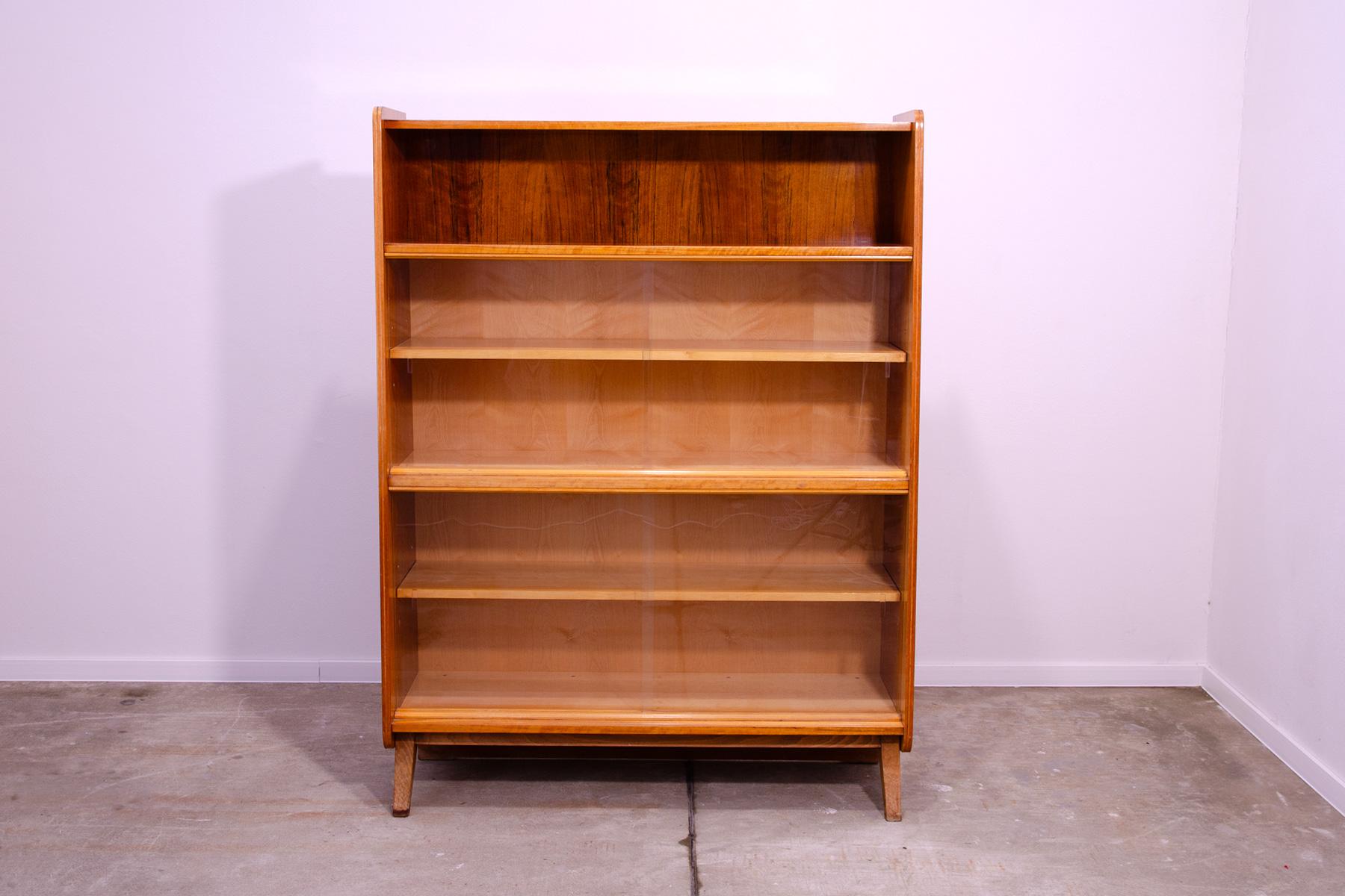 Mid century Vintage bookcase from the 1960´s. It was designed by František Jirák and was manufactured by Jitona company in the former Czechoslovakia. Features a simple design, a glazed section with five storage spaces. There is a slightly different