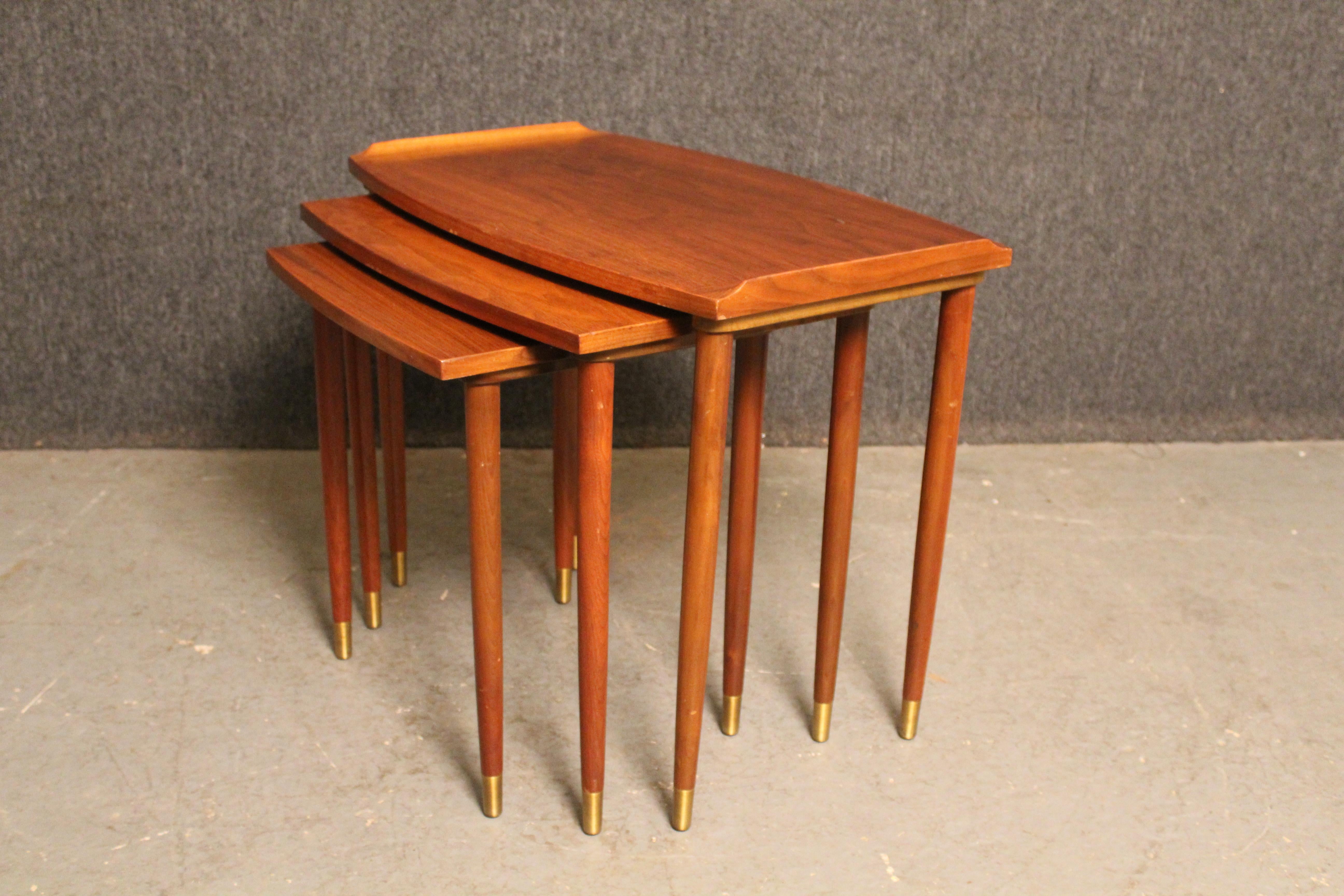 Terrific trio of mid-century vintage nesting tables constructed of beautiful American walnut showcasing a swirling natural wood grain. Coming in three distinct sizes- small (17.5