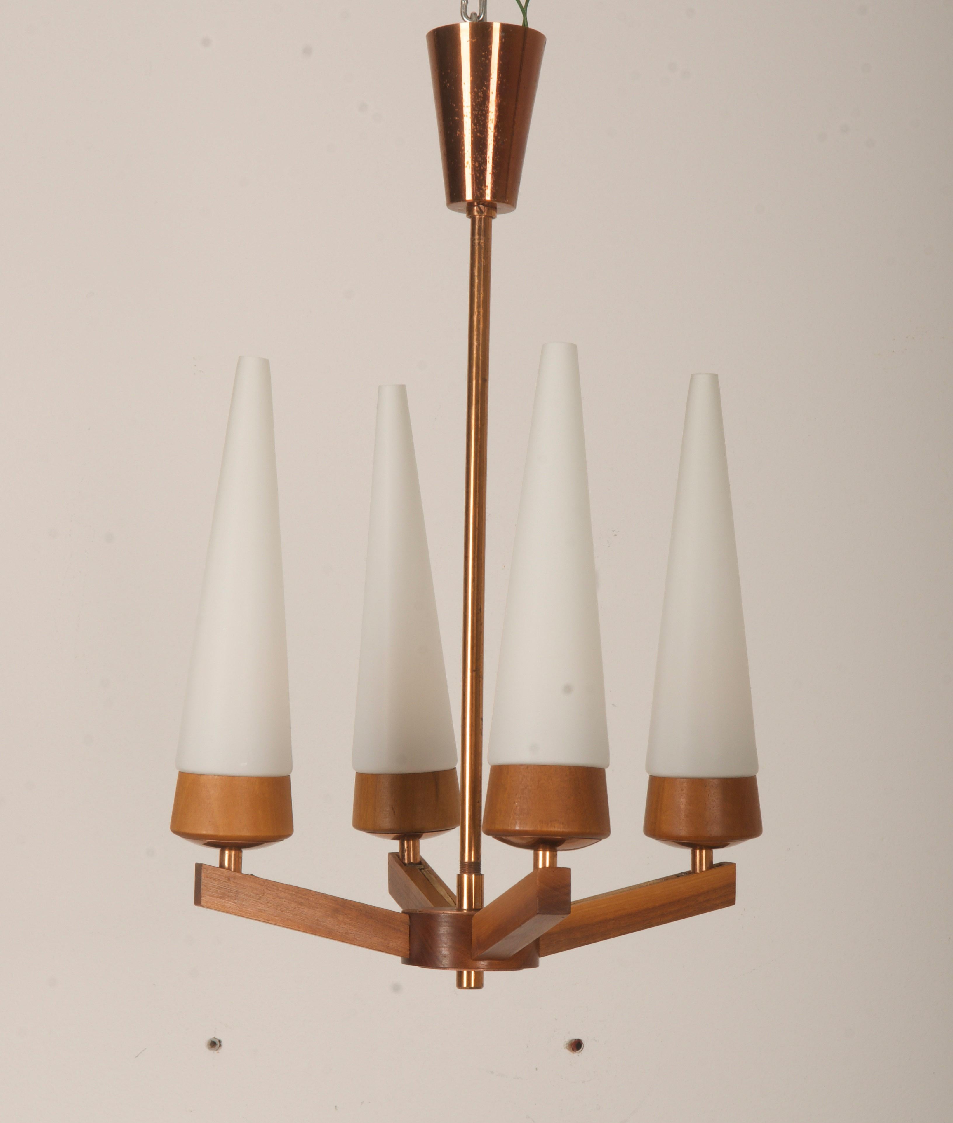 Brass, copper and walnut wood frame with 4 arms fitted each with E14 sockets and opaline glass shades. Manufactured in Vienna in the 1950 by Rupert Nikoll. 