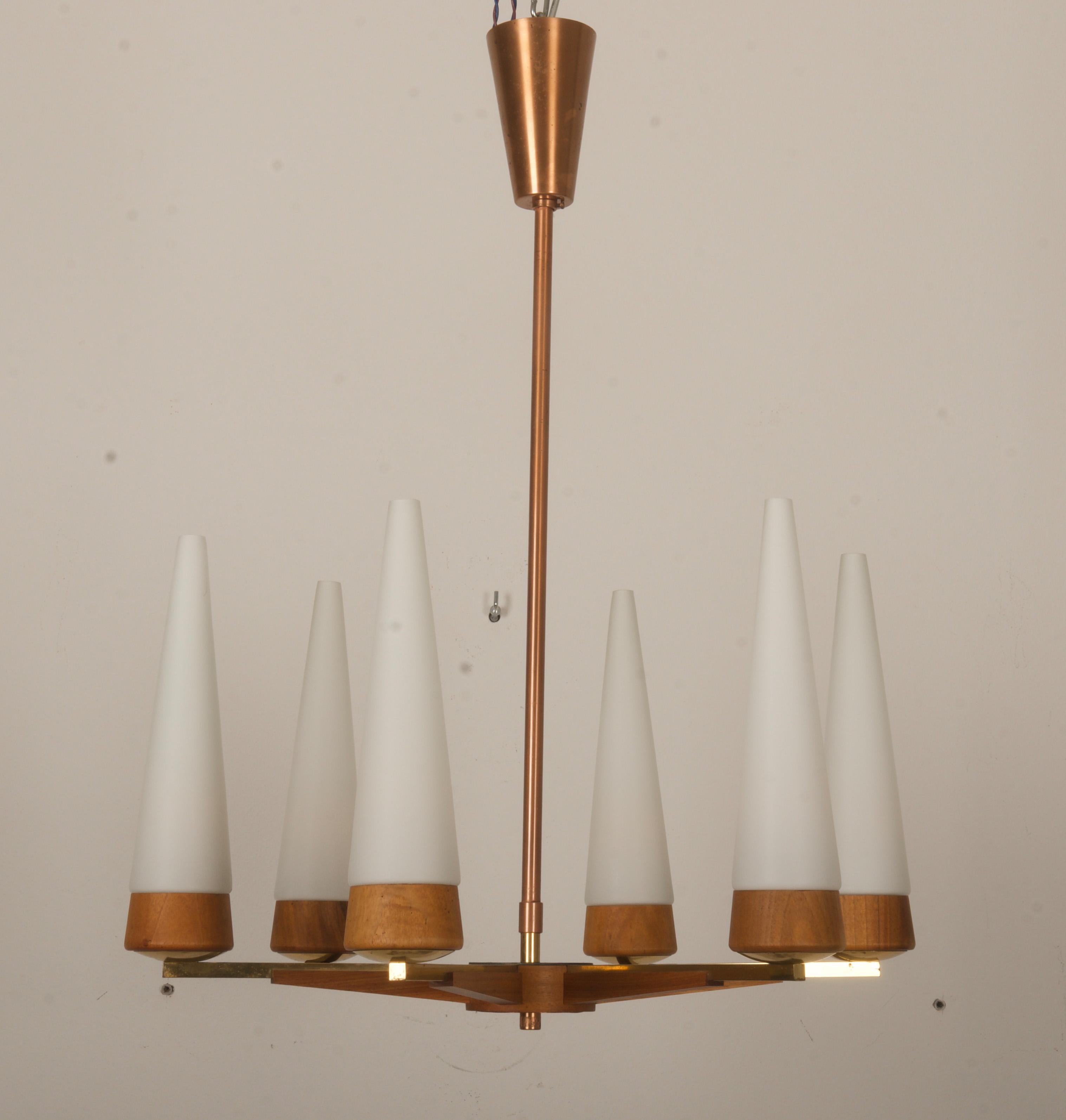Brass, copper and walnut wood frame with 6 arms fitted each with E14 sockets and opaline glass shades. Manufactured in Vienna in the 1950 by Rupert Nikoll. 