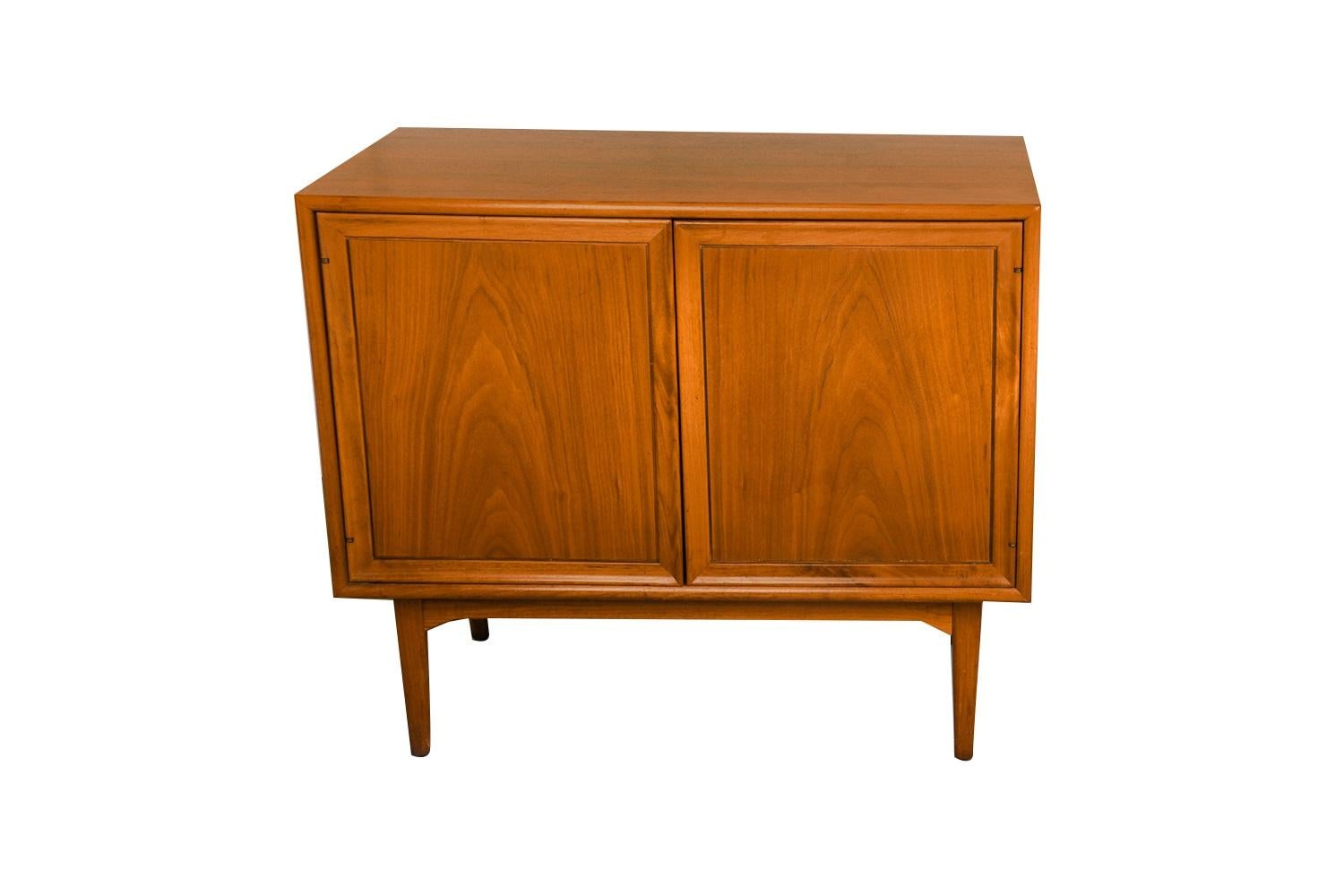 Beautiful Mid-Century Modern richly grained walnut double door cabinet designed by Kipp Stewart and Stewart MacDougall for Drexel’s Declaration Collection, circa 1960’s. Expertly crafted, remaining in clean vintage condition with a solid,