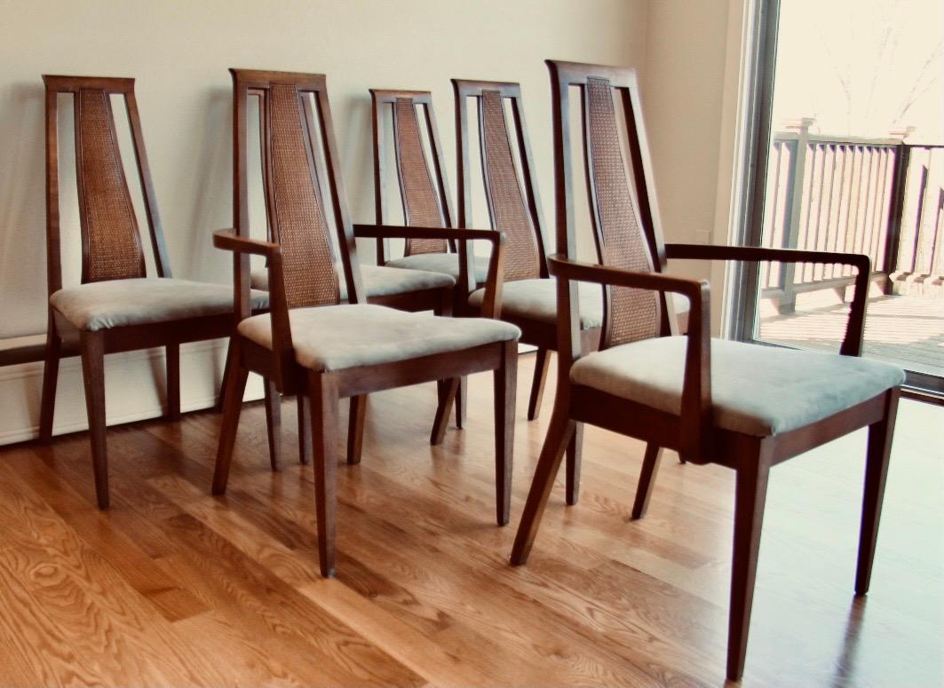 Mid century set of 6 chairs consist of two (2) arm chairs and four (4) side chairs all with molded Walnut and Cane back supports. The entire set is in very good condition with cane totally intact and the chair seats have been upholstered in gray. By