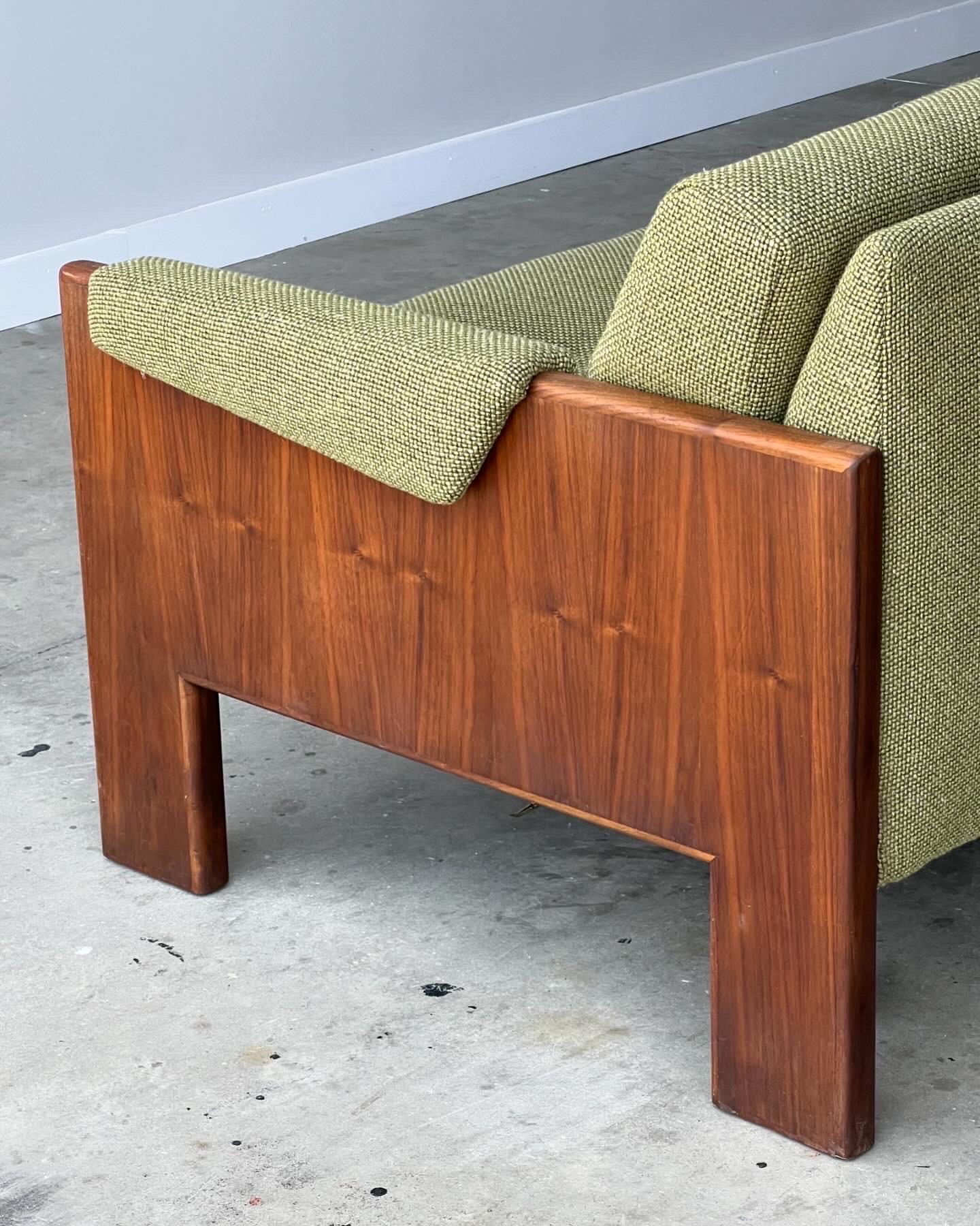 Mid-century walnut case sofa newly upholstered in a thick green knit fabric that’s very durable and vibrant. Padded arm inserts and angled back cushions gives it a very stylish and dynamic look similar to Milo Baughman or Italian design of the