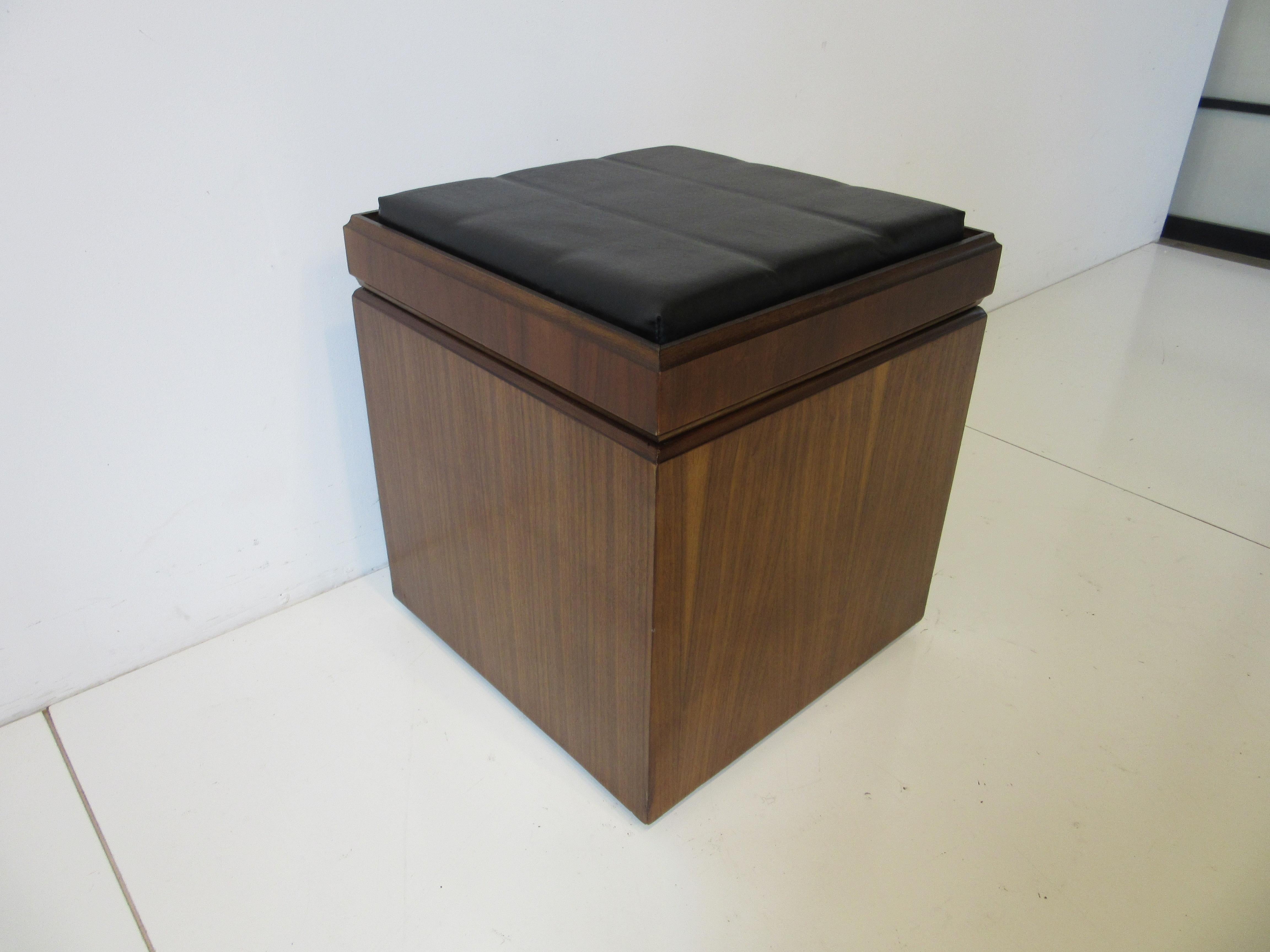 A square dark walnut stool with black leatherette top which can be turned over to expose a walnut chess board . Additionally the inside box has three slots for vinyl record storage which can hold a few dozen or more of your favorite albums . This is
