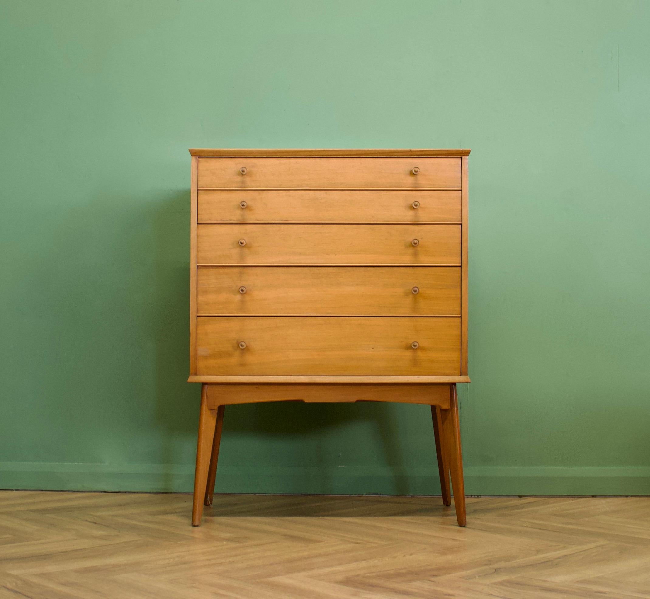 An impressive quality, tall walnut chest of drawers from Alfred Cox - retailed through Heal's during the 1950s
The bank of five drawers stands on long, tapered, splayed legs
The manner of construction of the legs means they are very sturdy and
