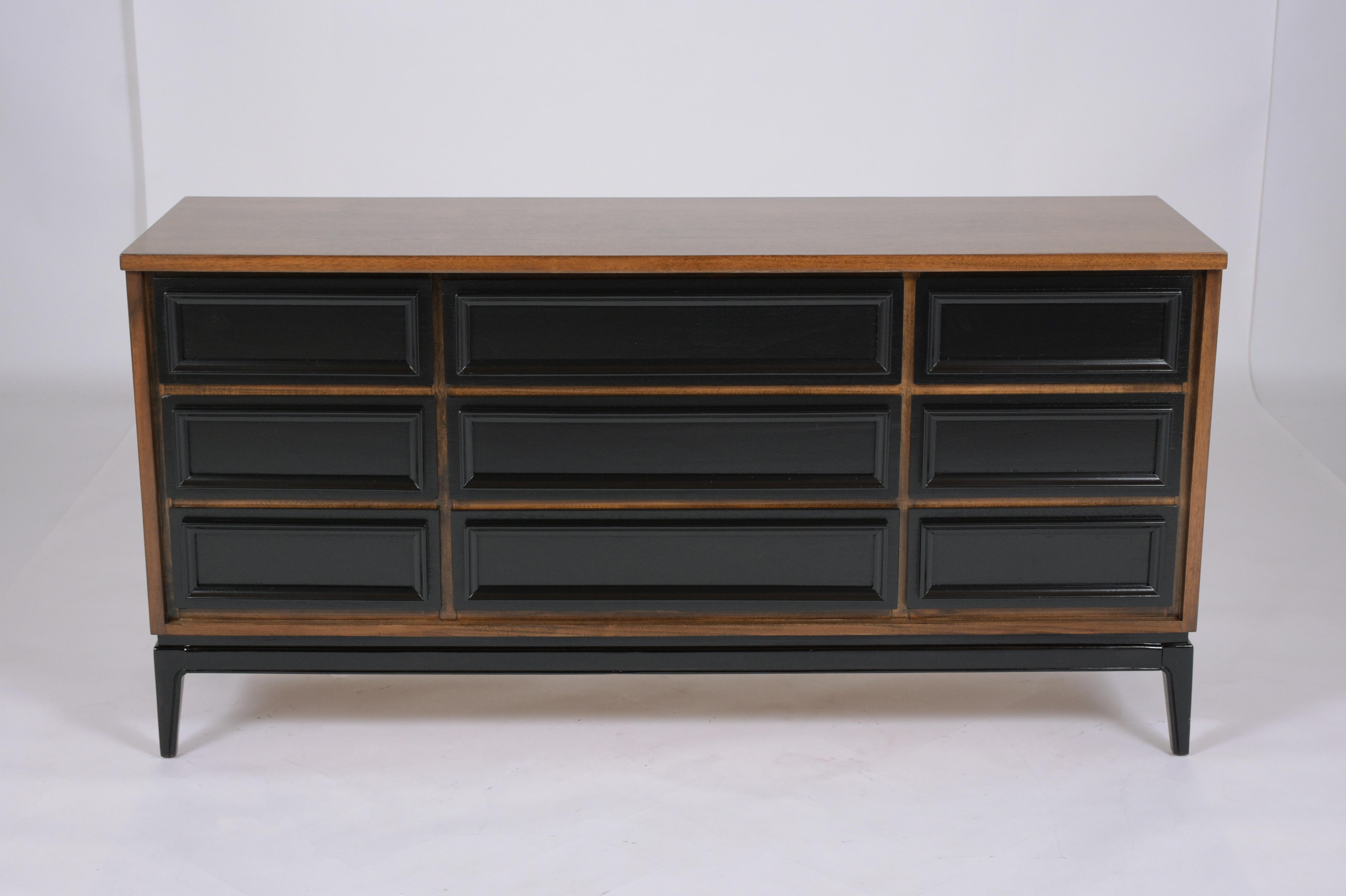 An extraordinary mid-century modern dresser hand-crafted out of wood in an excellent condition completely restored and refinished by our craftsmen team. This dresser is eye-catching featuring a great ebonized and dark walnut color combination with