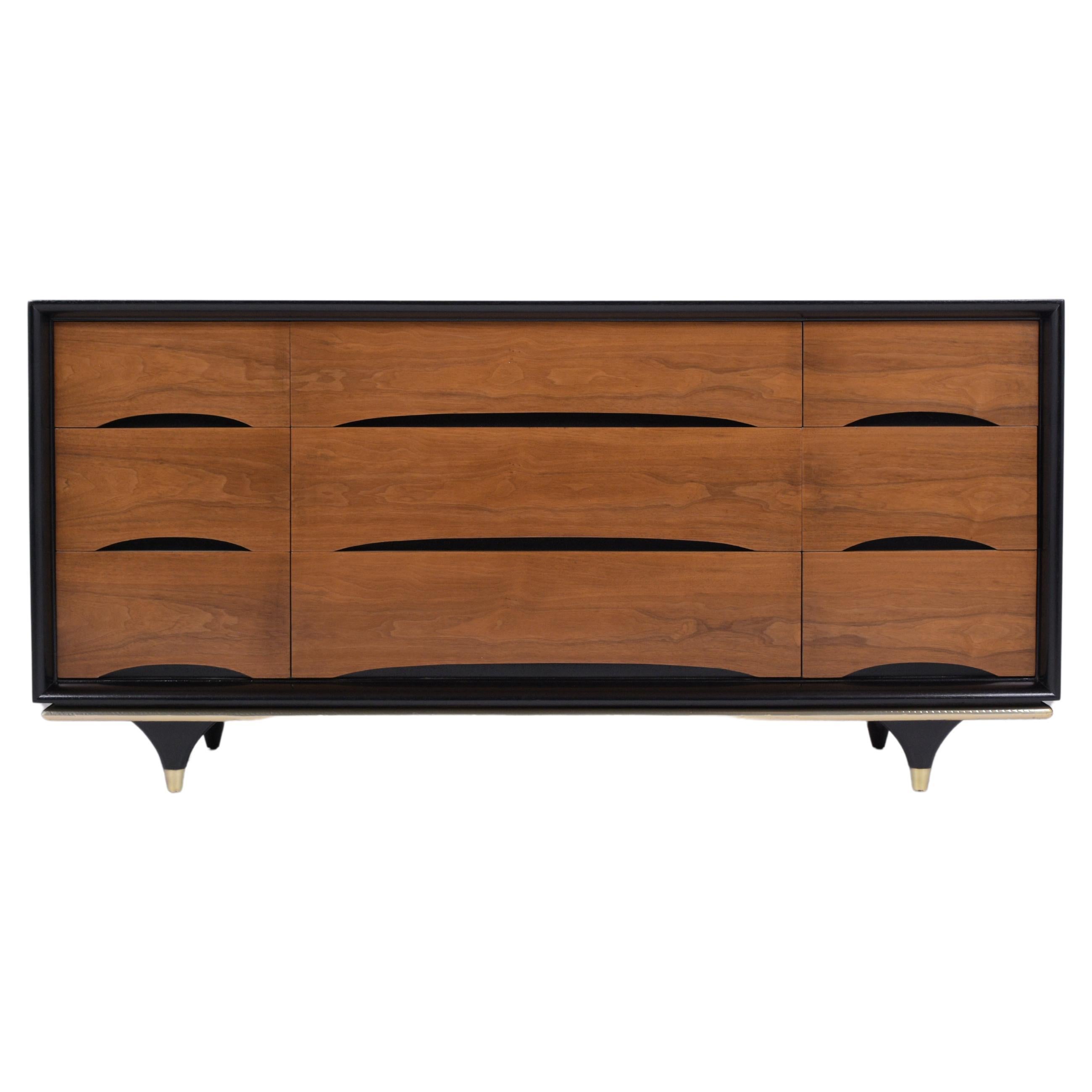 Discover the sophisticated charm of our Mid-Century Modern Walnut Chest of Drawers, a true gem from the vintage era. This chest, meticulously hand-crafted from premium walnut, showcases exceptional craftsmanship and timeless design. The restoration