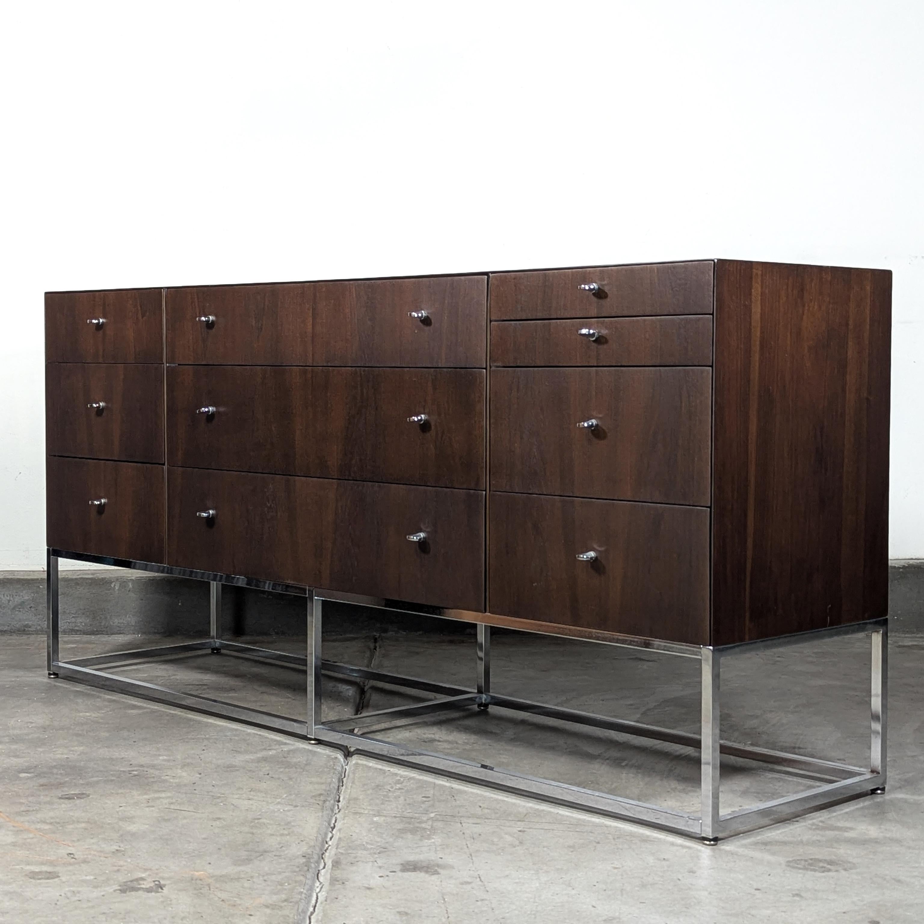 Introducing a stunning vintage mid-century modern Kipp Stewart 10-drawer walnut dresser, a true statement piece that effortlessly combines style and functionality. This exquisite dresser is elegantly supported by a sleek structural chrome base,
