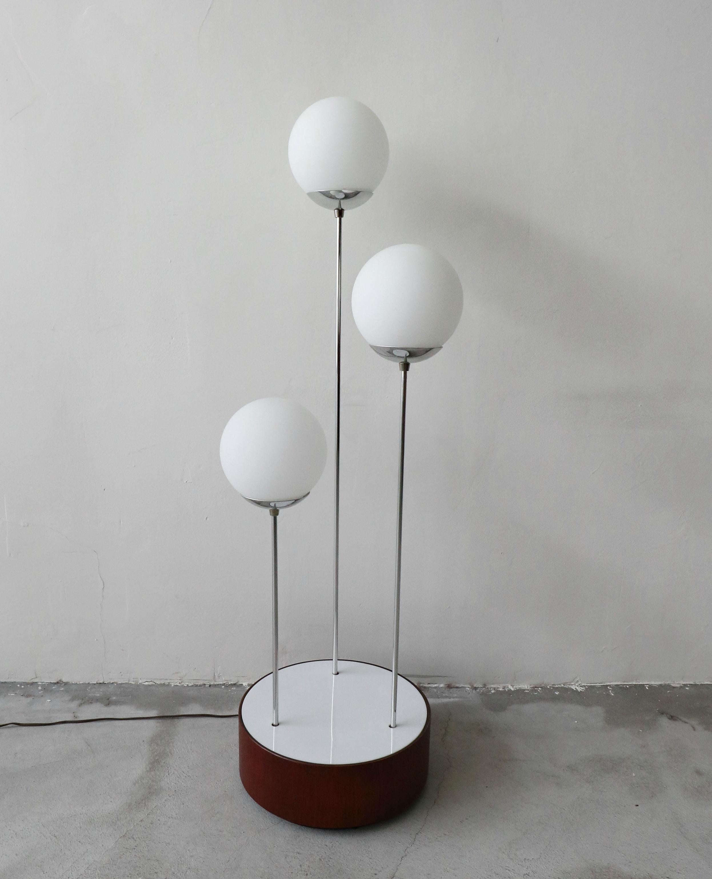 This is a gorgeous, all original midcentury lamp, date stamped December 2, 1976. Lamp is comprised of a walnut drum with an acrylic covered, illuminated base and 3-tiered chrome poles that have frosted glass globes. It is perfect for use on an