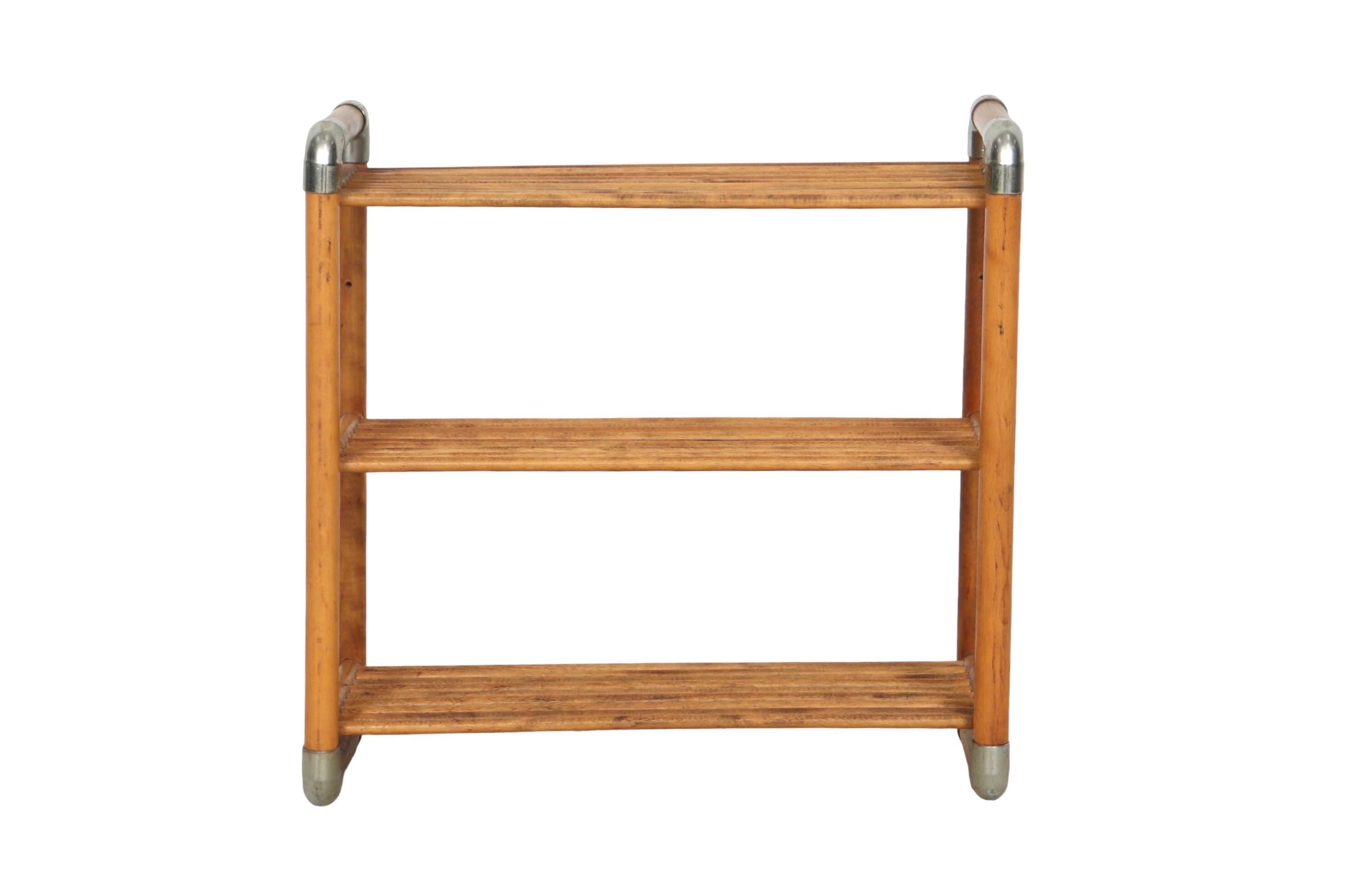 A mid-century free-standing set of shelves. Made of walnut with chrome corners. Three shelves are made with wooden slats. Could also be attached to a wall.

