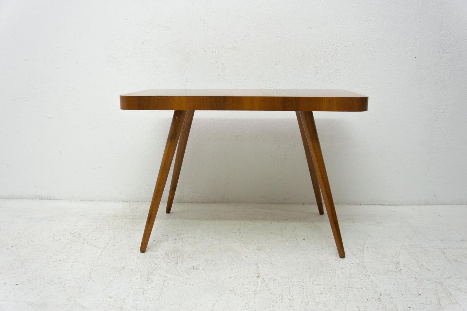 Midcentury walnut coffee table, made in the former Czechoslovakia in the 1960s.

Associated with the world-renowned exhibition EXPO 58 in Brussels. It was produced by Ceský nábytek company. It´s made of walnut with beech legs. In very good vintage