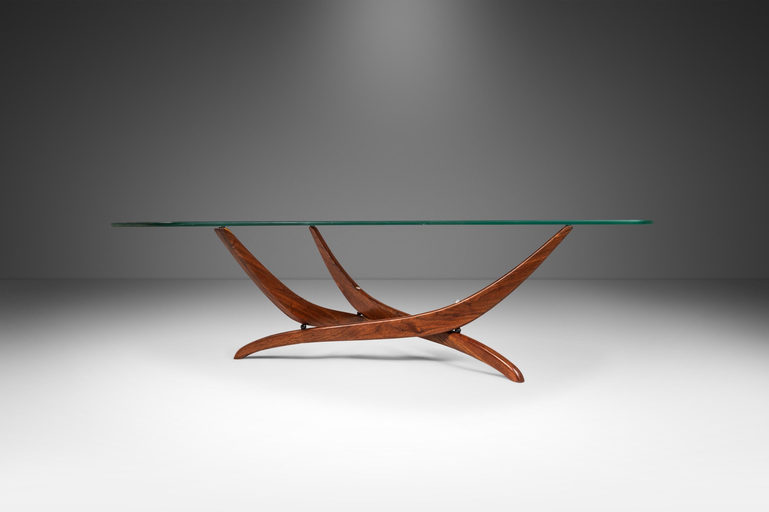  Introducing an iconic sculptural coffee table by Forest Wilson. Featuring intricately carved solid walnut legs that borrow from fluid forms found in nature, it’s almost as if Wilson is contouring the beams of walnut back to their original shape as