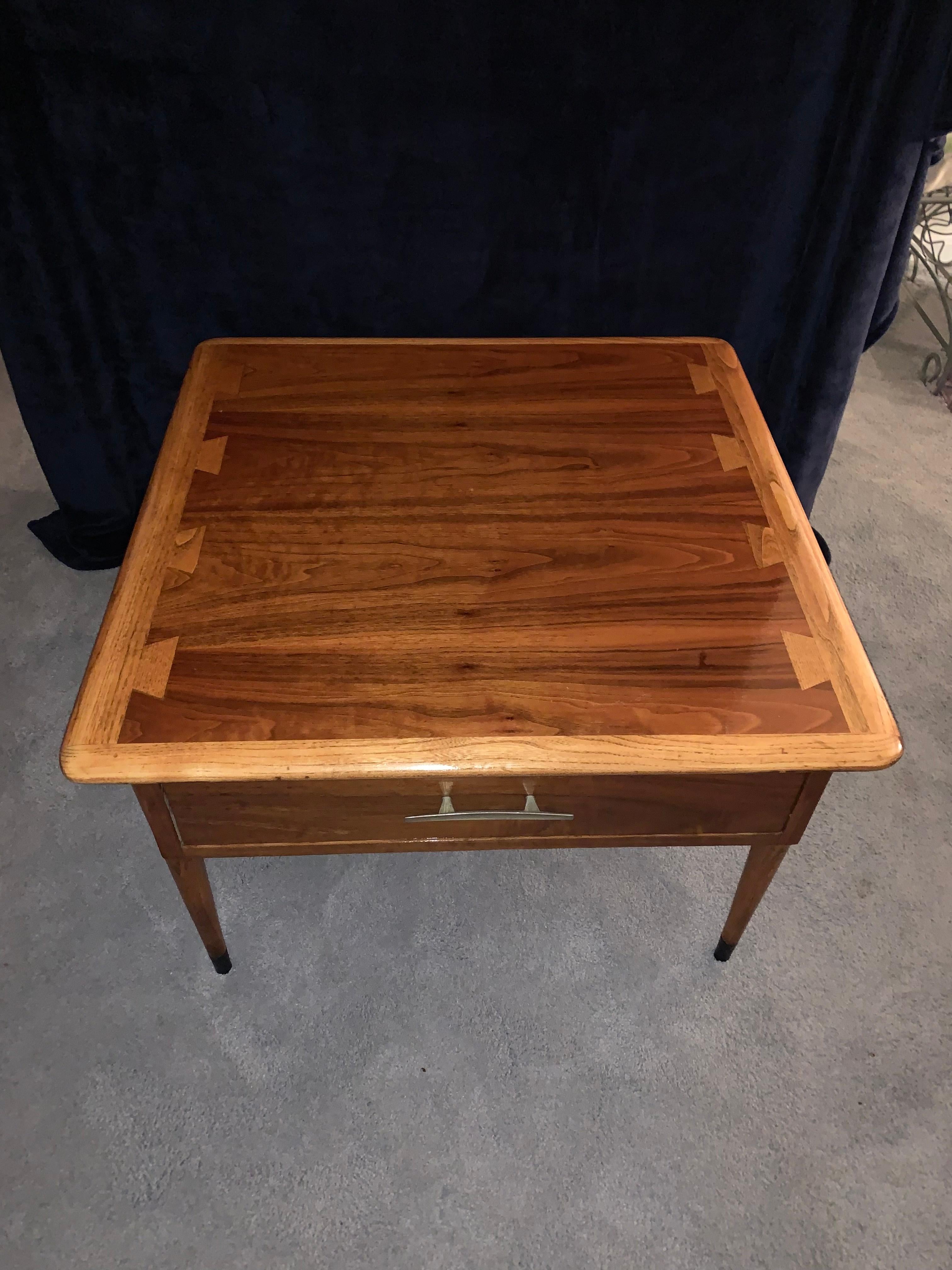 Mid-Century walnut commode table by Lane, Acclaim. Walnut side table with drawer by Lane Furniture, part of the Acclaim line designed by Andre Bus showcasing his iconic two-tone wood dovetail, using walnut and fruit woods. Beautiful square top wood