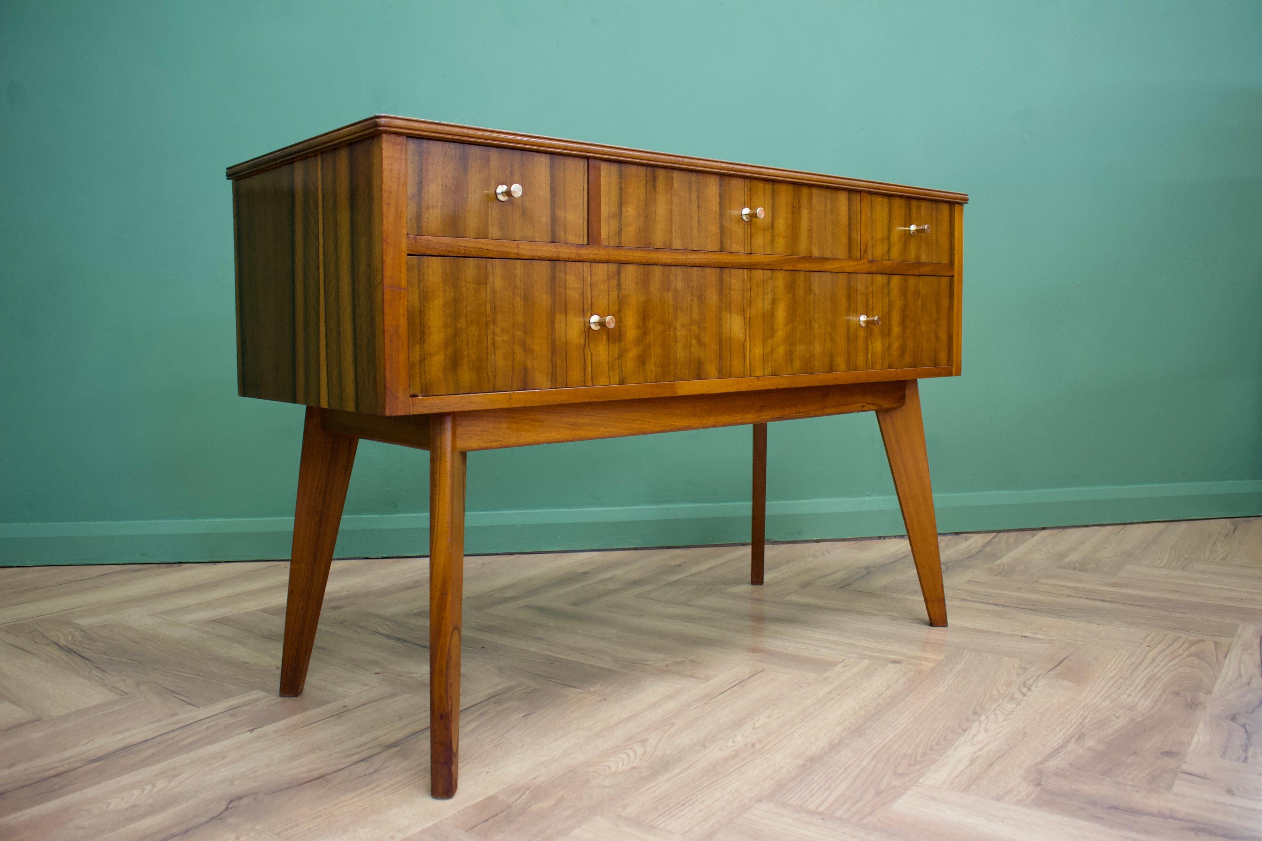 - Mid-Century Modern compact sideboard - dating from the 1950s.
- Manufactured in the UK by Morris of Glasgow 
- Features four drawers.