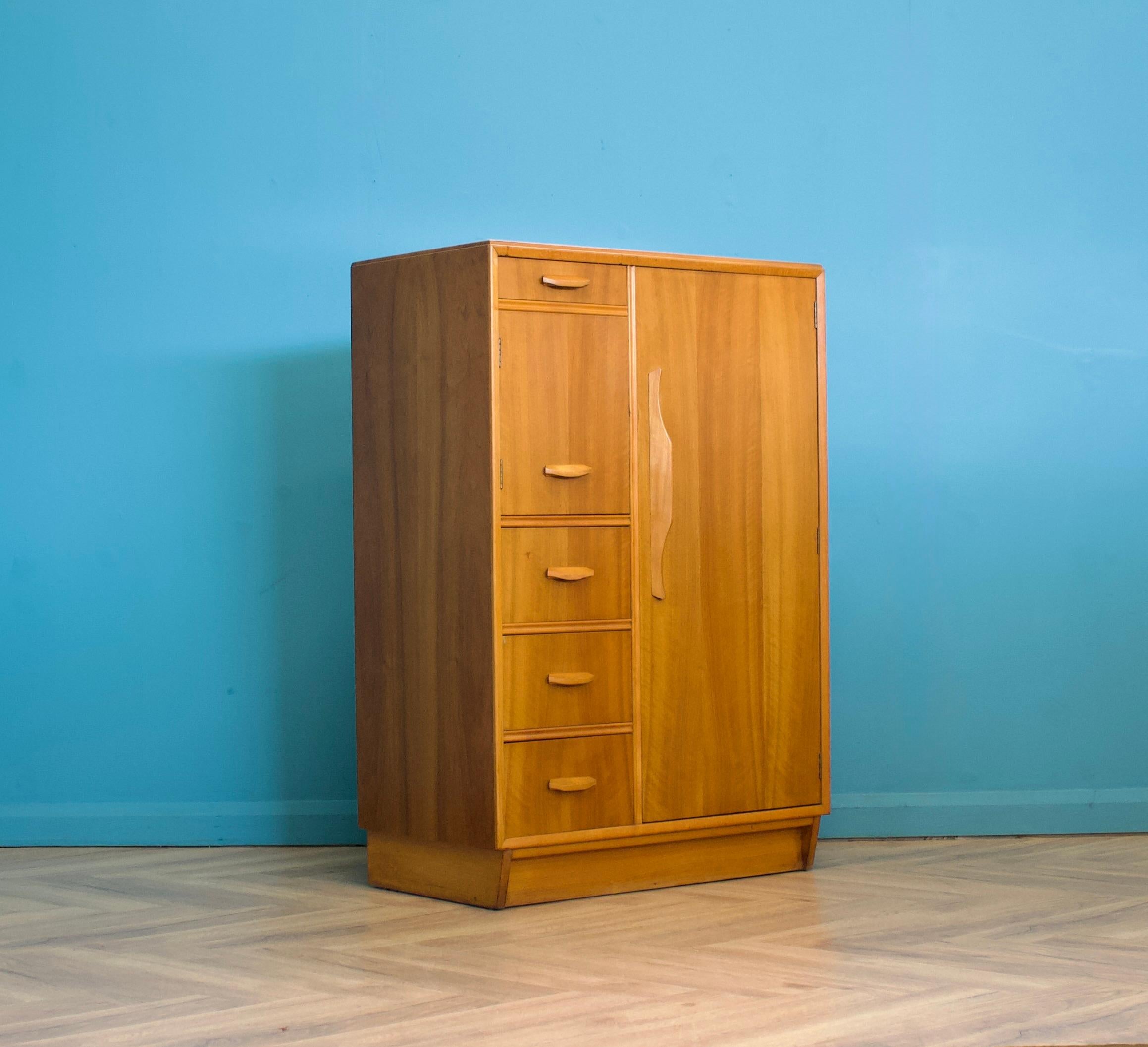 A compactum walnut wardrobe, in the manner of Heals - circa 1950s
There's a lot of storage in such a compact piece - one compartment has a pull out hanging rail, another compartment has a shelf. There are four drawers - one has an integrated pull