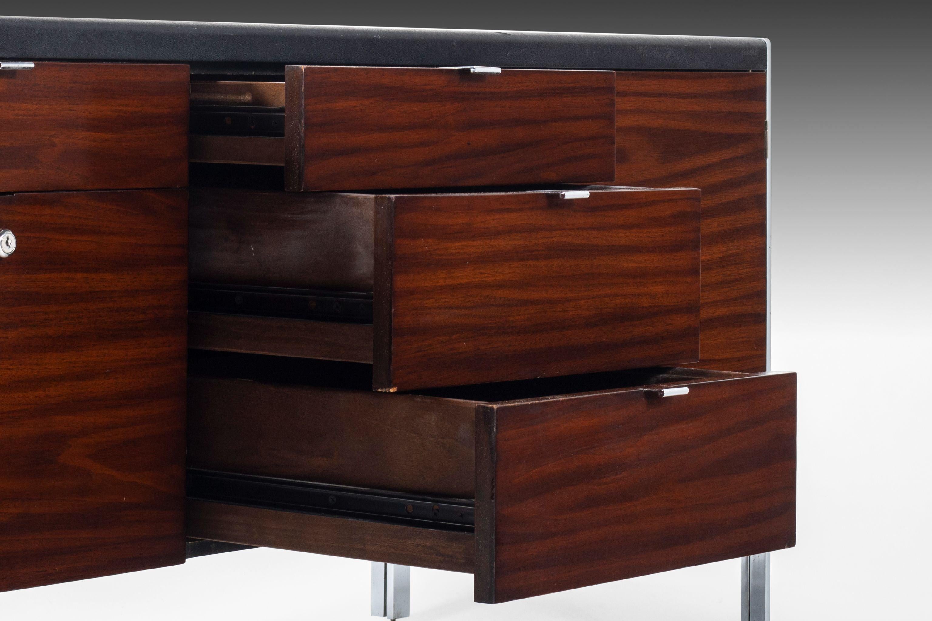 Constructed from walnut and chrome polished steel. The cabinet is great for the office or for use at home. The top of the cabinet is found in it's original vinyl. The far left and right sides of the cabinet have ample storage cubies behind their