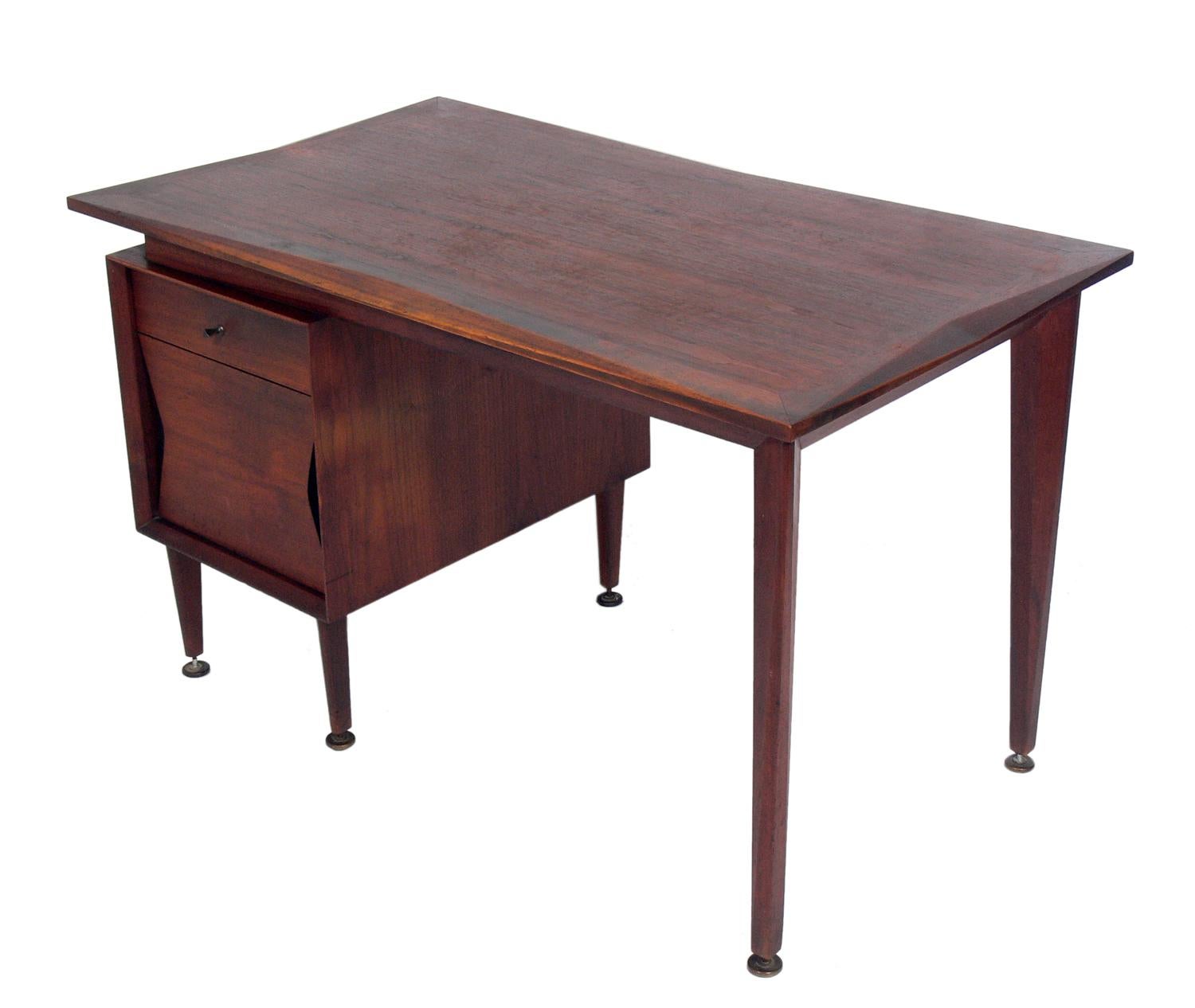 Midcentury walnut desk and chair, designed by Marc Berge for Grosfeld House, American, circa 1960s. This desk and chair are currently being refinished and can be completed in your choice of color. The chair is being reupholstered and can be