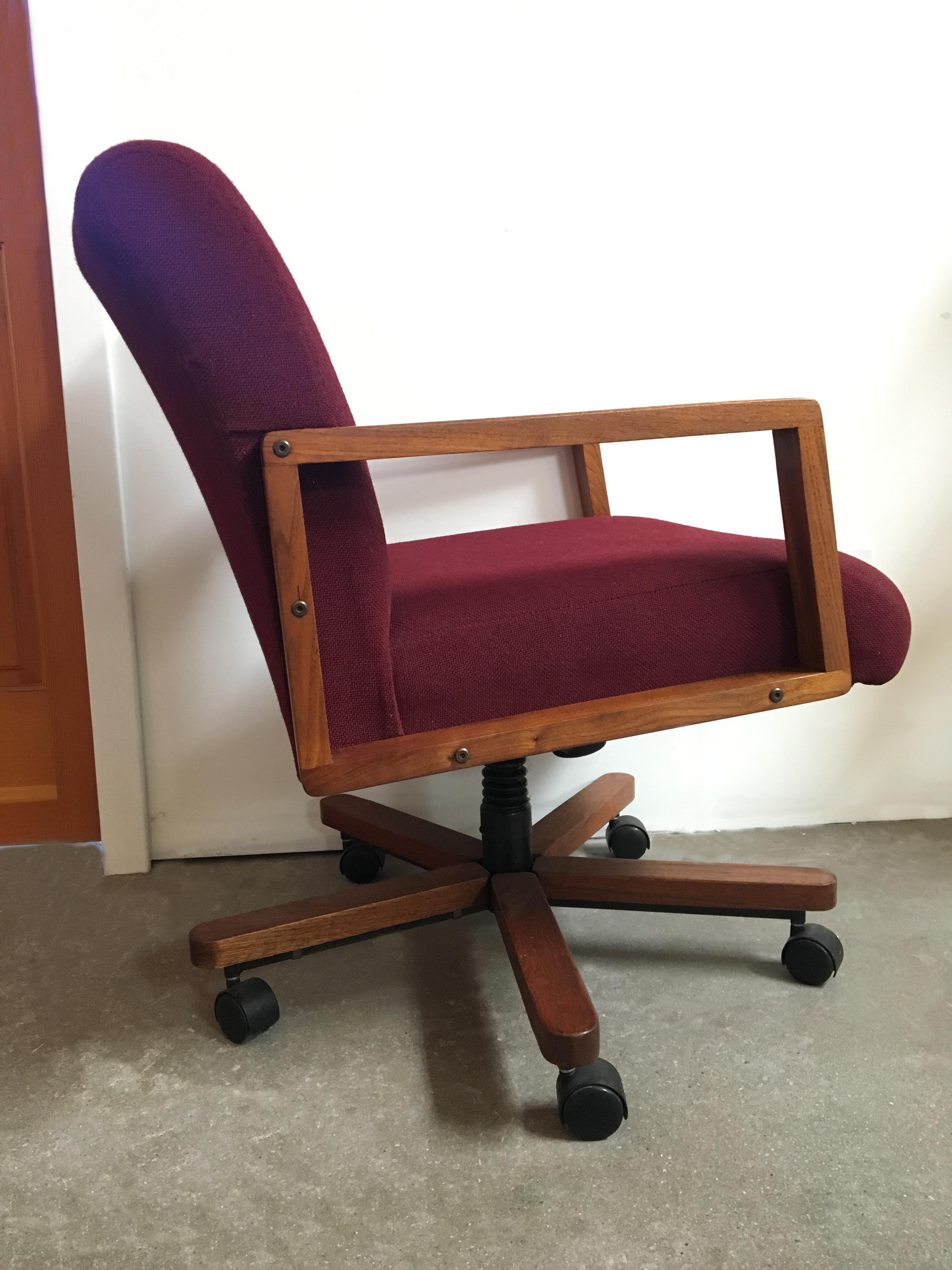 Solid walnut tilting, swiveling desk chair.
