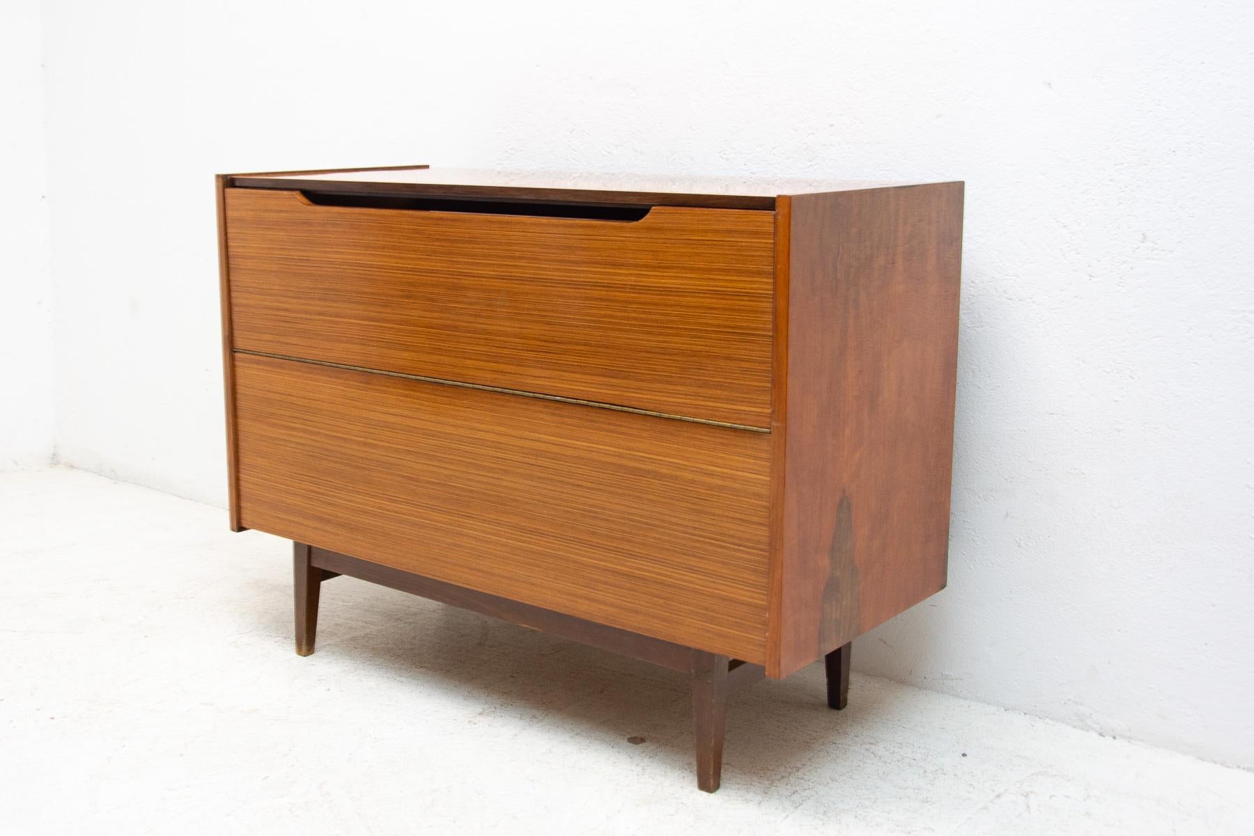 This mid century dresser was made in the former Czechoslovakia in the 1970´s. Most likely by Interiér Praha.
Beautiful walnut veneer.

It can also be used as a TV table or bar.
In very good Vintage condition, showing slight signs of age and