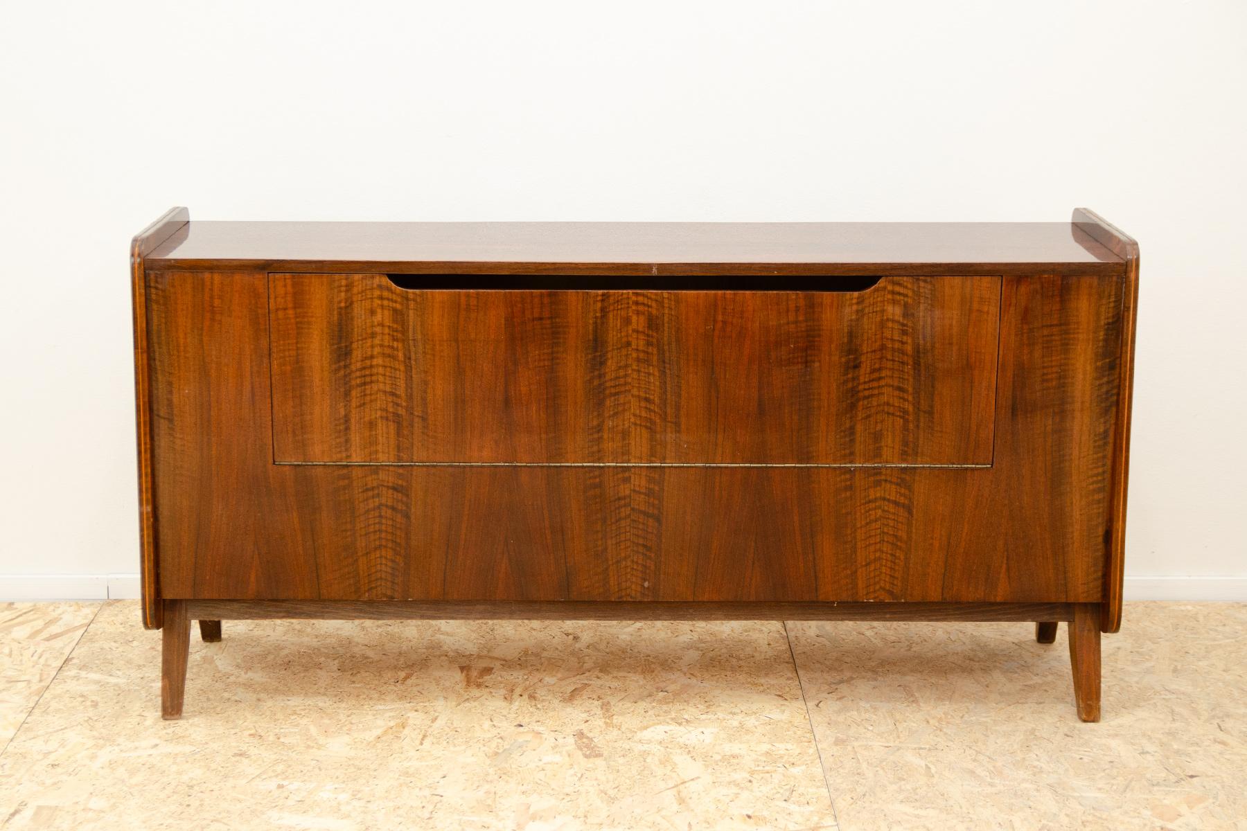 This mid century dresser was made in the former Czechoslovakia in the 1970´s. It was designed by František Jirák fo Tatra nábytok company. It has beautiful walnut veneer. It can also be used as a TV table or bar.
In very good Vintage condition,