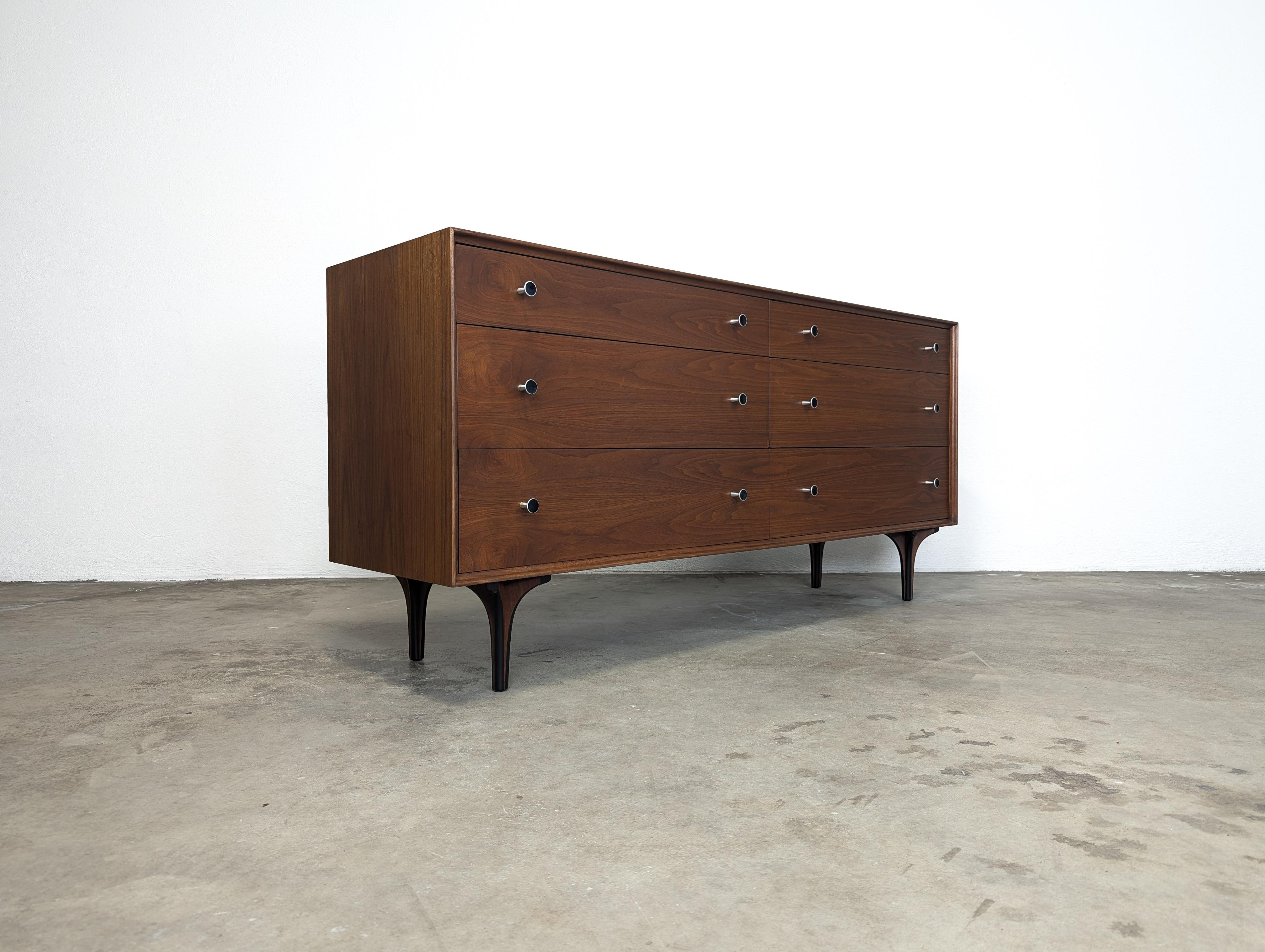 For sale is a stunning Mid Century Modern dresser designed by the renowned Robert Baron for Glenn of California, dating back to the 1960s. This exquisite piece measures approximately 64.75 inches wide, 18 inches deep, and 30.5 inches high, and has