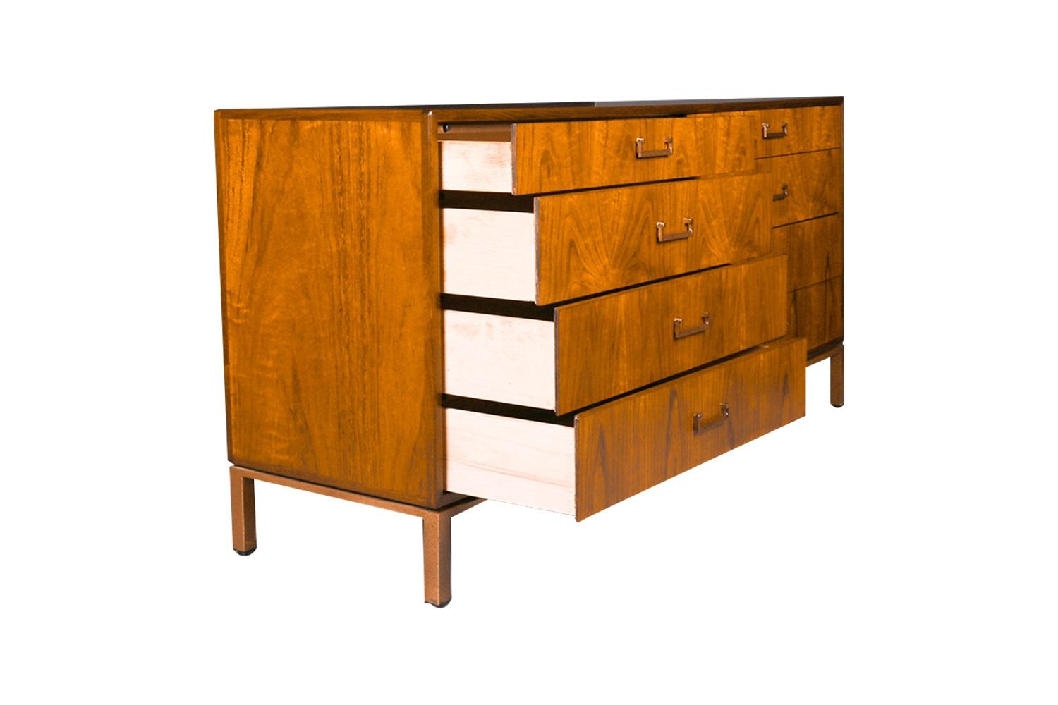 Handsome, richly grained walnut Mid-Century Modern 8 drawer dresser, attributed to Jack Cartwright for Founders Furniture Company, USA circa 1960’s. Expertly crafted, this absolute jewel remains in beautiful clean vintage condition. Features a