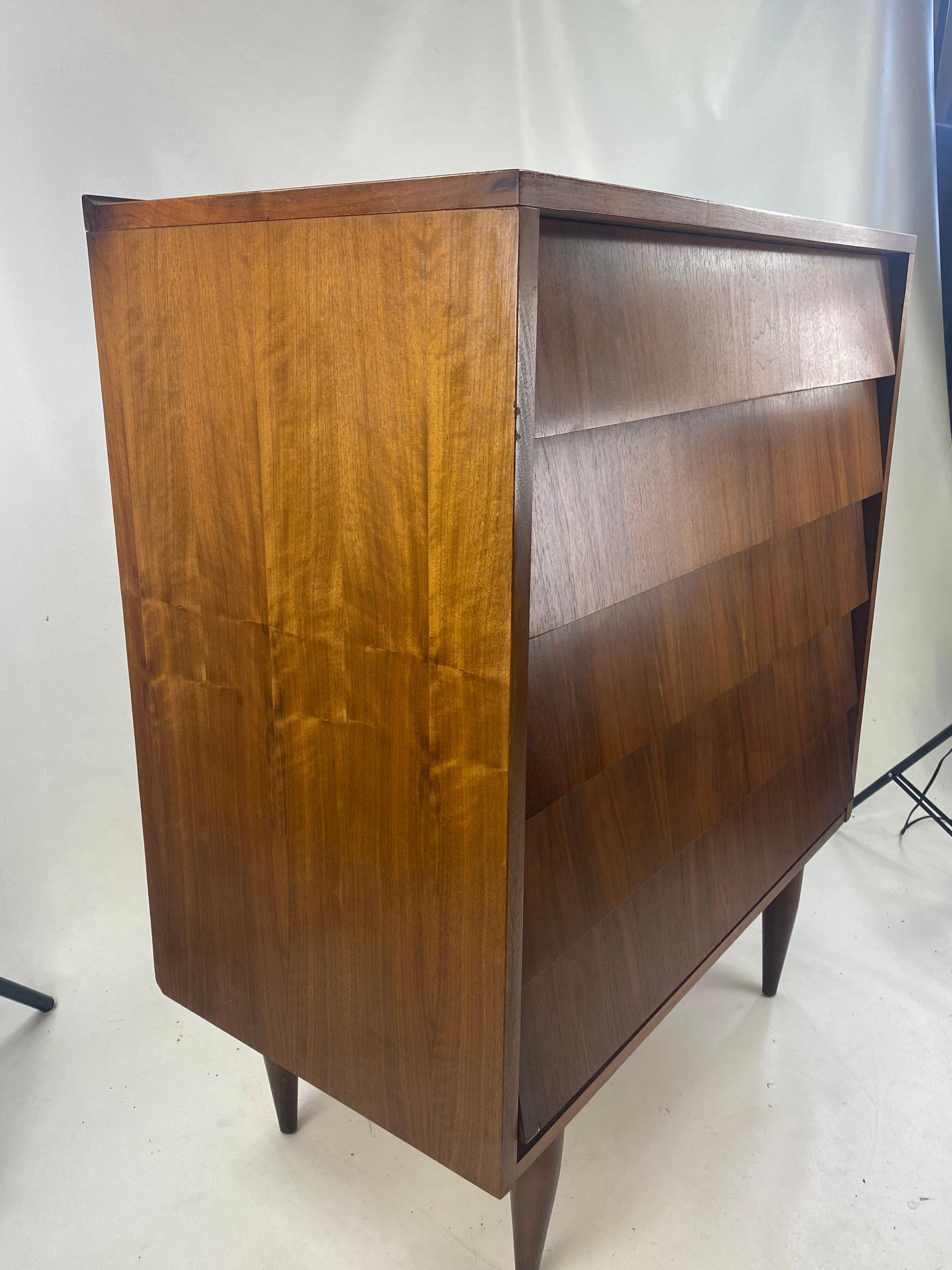 Midcentury walnut dresser with louvered drawers.
