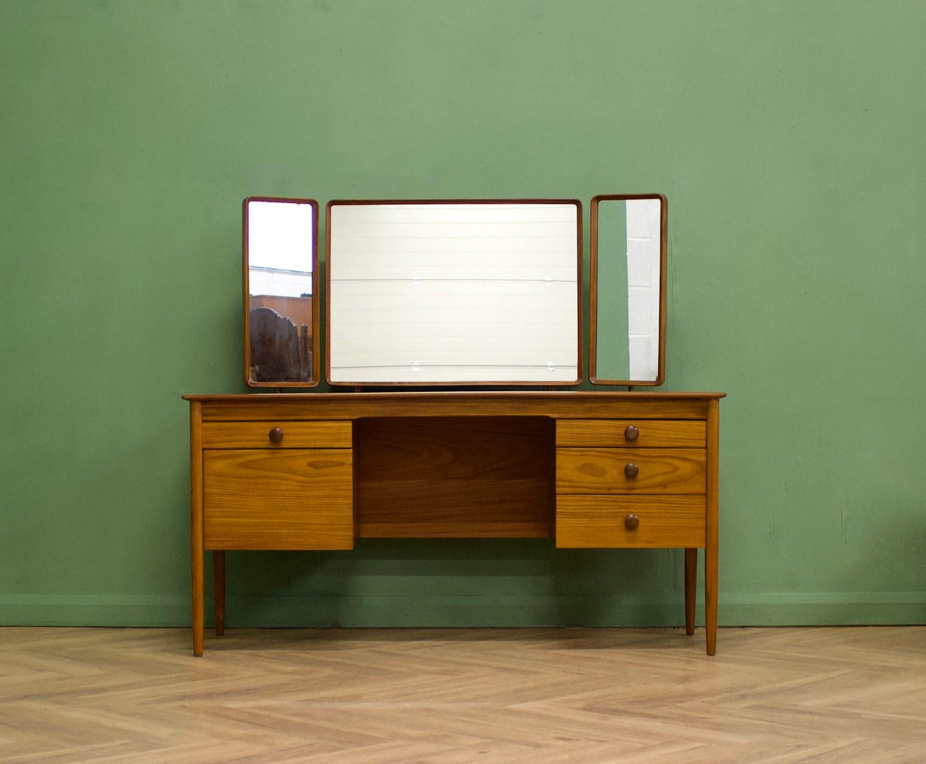 A mid century teak dressing table from Butilux - a little known about high quality furniture makers, circa 1960's
Complete with a triptych mirror - all three are adjustable either by tilting or swiveling
There are three drawers in total and a