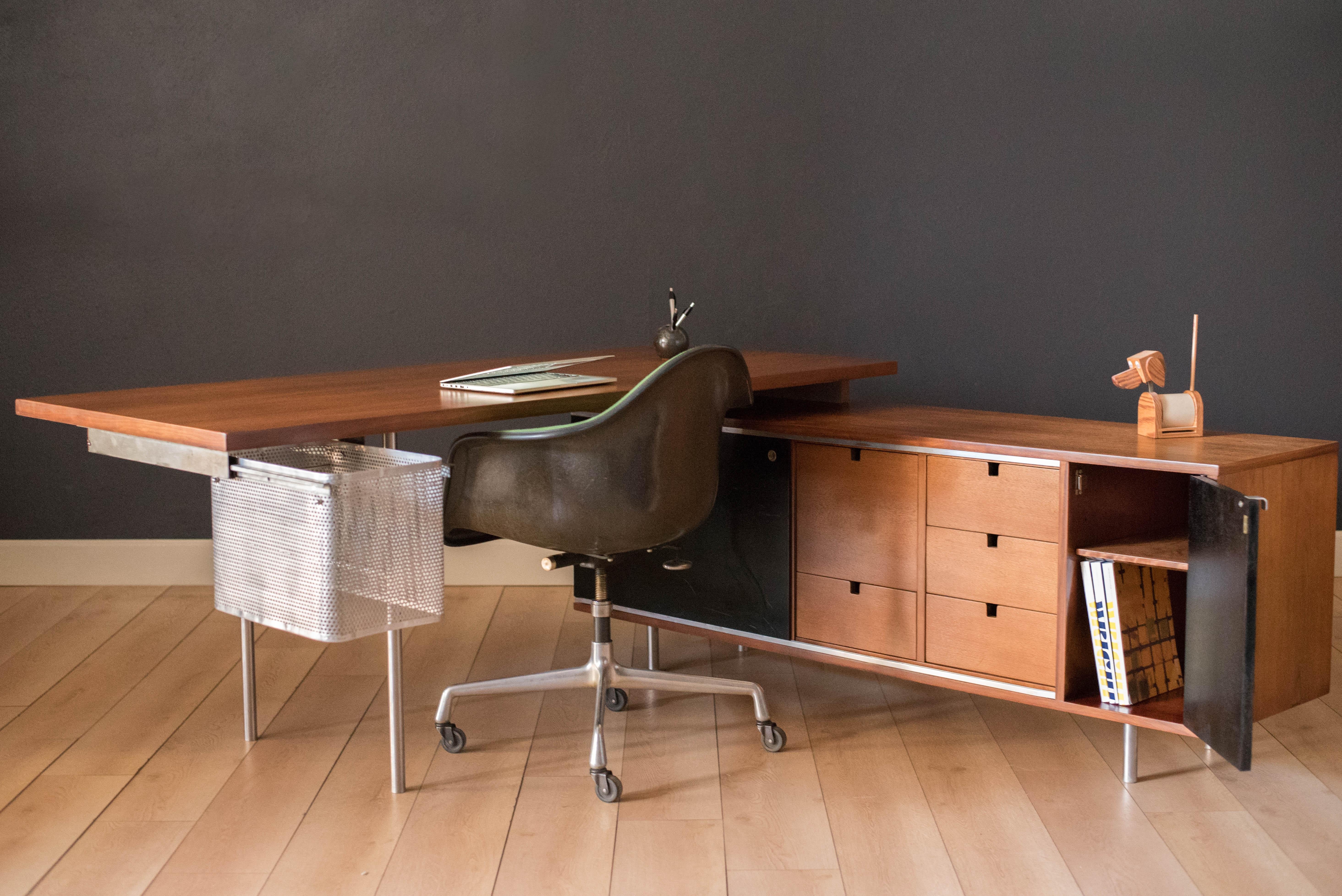 Vintage executive desk and return designed by George Nelson for Herman Miller in walnut. This floating desktop provides ample work surface space and plenty of storage solutions. Includes a rare metal extension filing basket with an additional filing