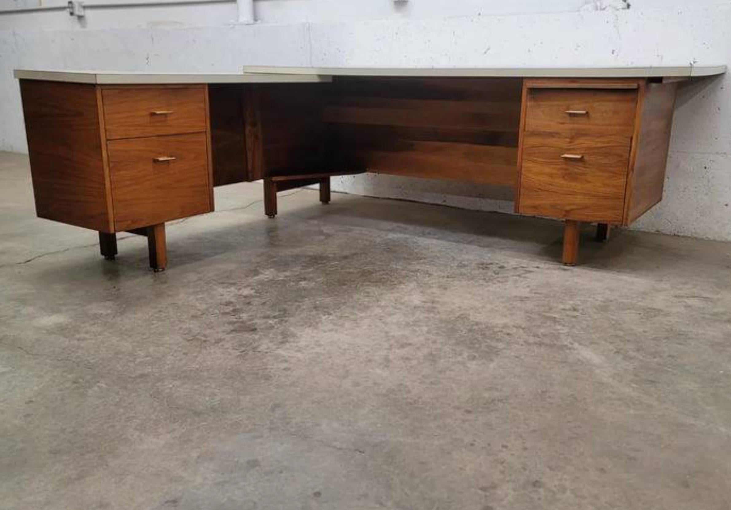 A single estate 1960s custom made Walnut executive desk with left-hand return

It features three drawers, a cabinet and a pull out writing slab as well as a clean and crisp white laminate top.

Sourced in Colorado from the original, single owner.