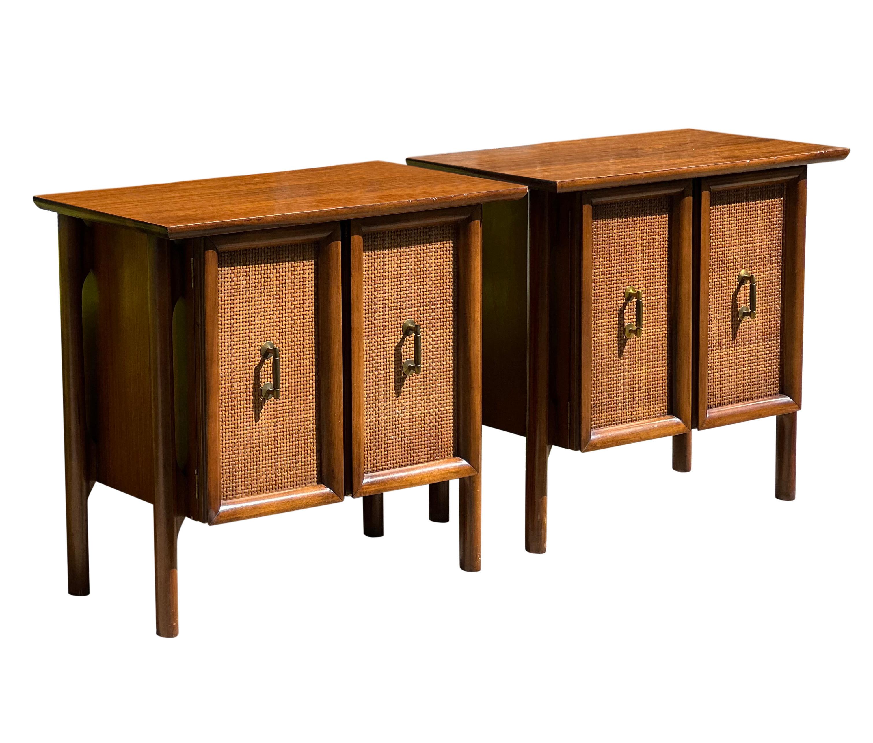 Exceptional Mid Century walnut floating nightstands with cane panel doors.

The nightstands feature floating cabinetry within a sculptural walnut frame with straight, rounded legs. The woven rattan panels are framed by raised, curved walnut. Each