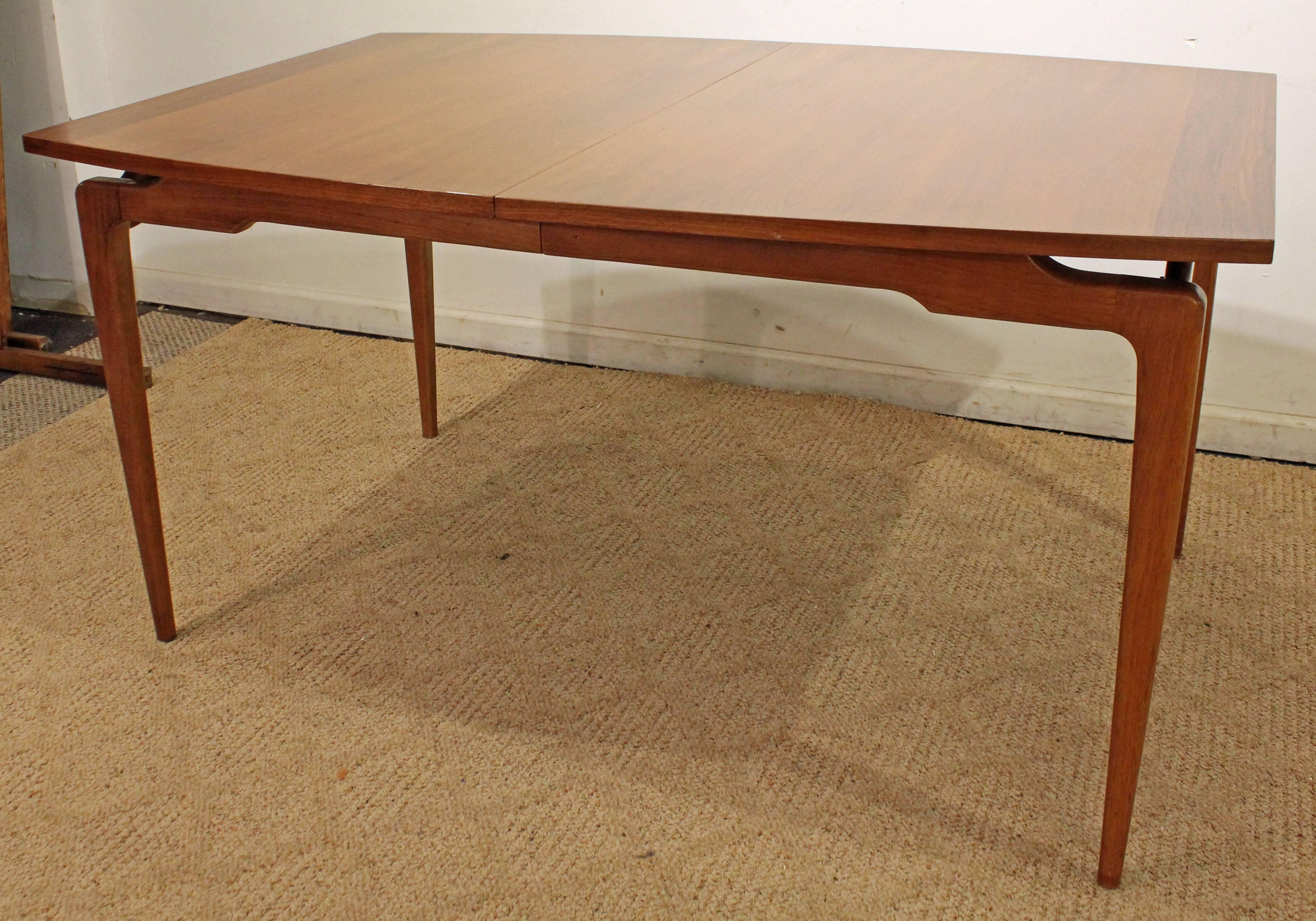 The table is made of walnut and has a floating base. It was made by Young Mfg Co. 

Dimensions: 
w/ extension 58
