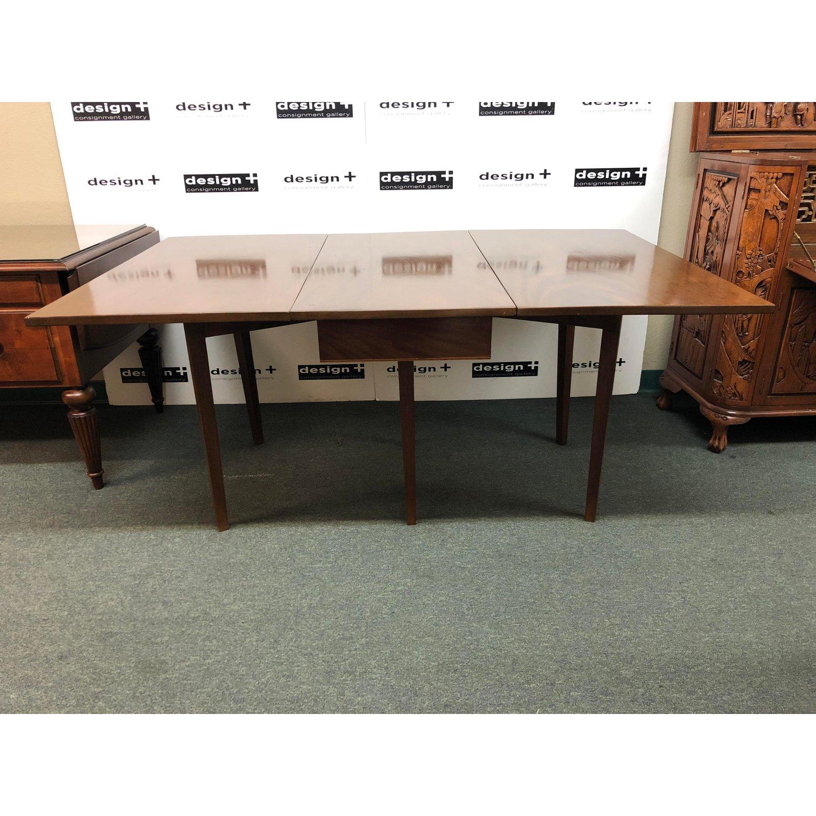 Design Plus Gallery presents a midcentury gate leg table or console. Simple clean silhouette and lightly tapered legs allow the table to work with many styles of decor. Rich woodgrain is evident when used as a console, and more so when expanded for