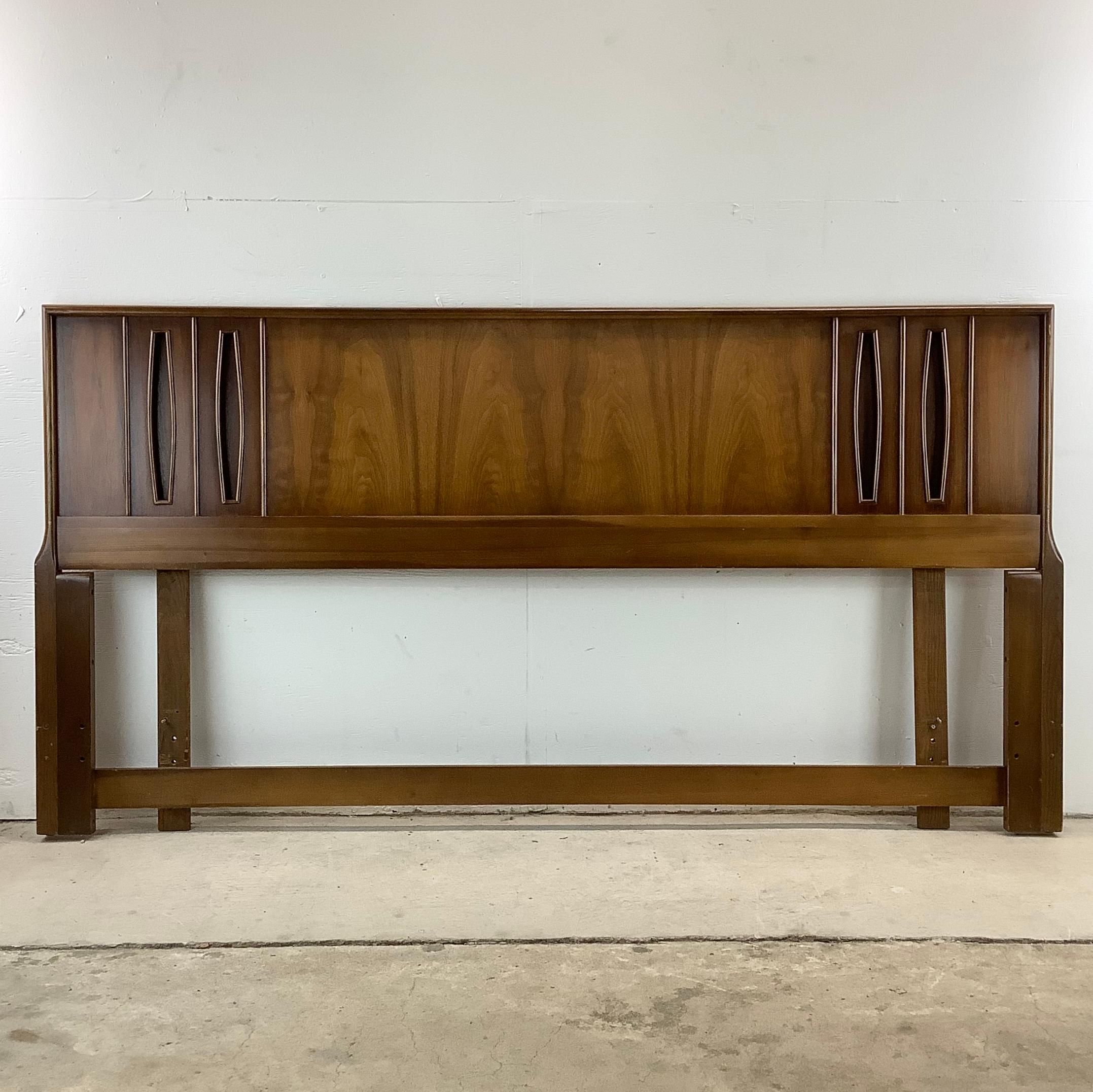 This exquisite Mid-Century Modern King Size Headboard captures the essence of a time when design transformed the mundane into the magnificent. Crafted from sumptuous vintage walnut, a wood revered for its rich hues and intricate grain patterns, this